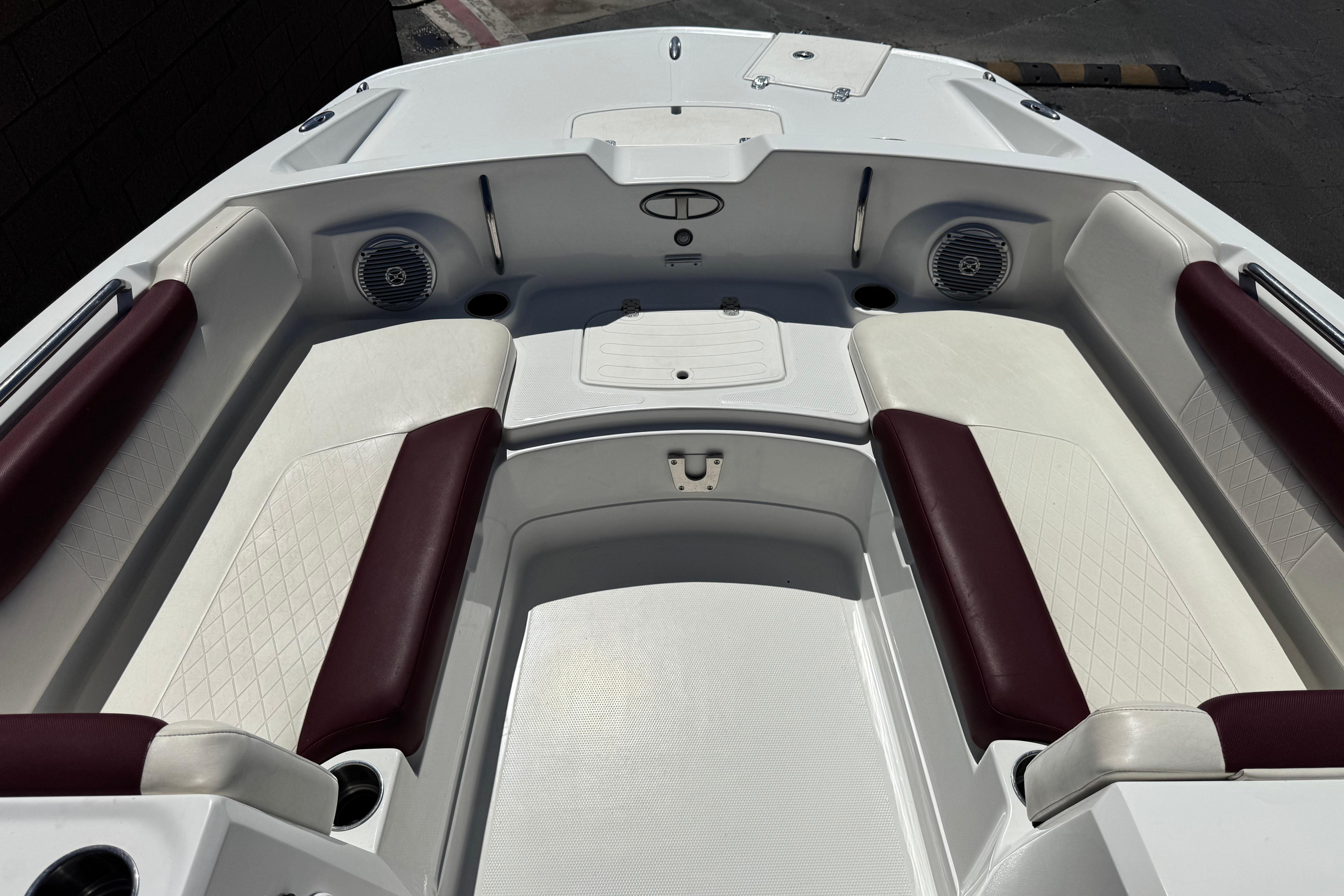 2017 Tahoe 2150 boat interior with white and maroon seating, featuring built-in speakers.