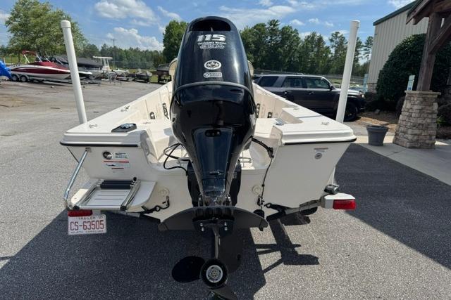 2023 Carolina Skiff 192 JLS boat with outboard motor, parked outdoors.