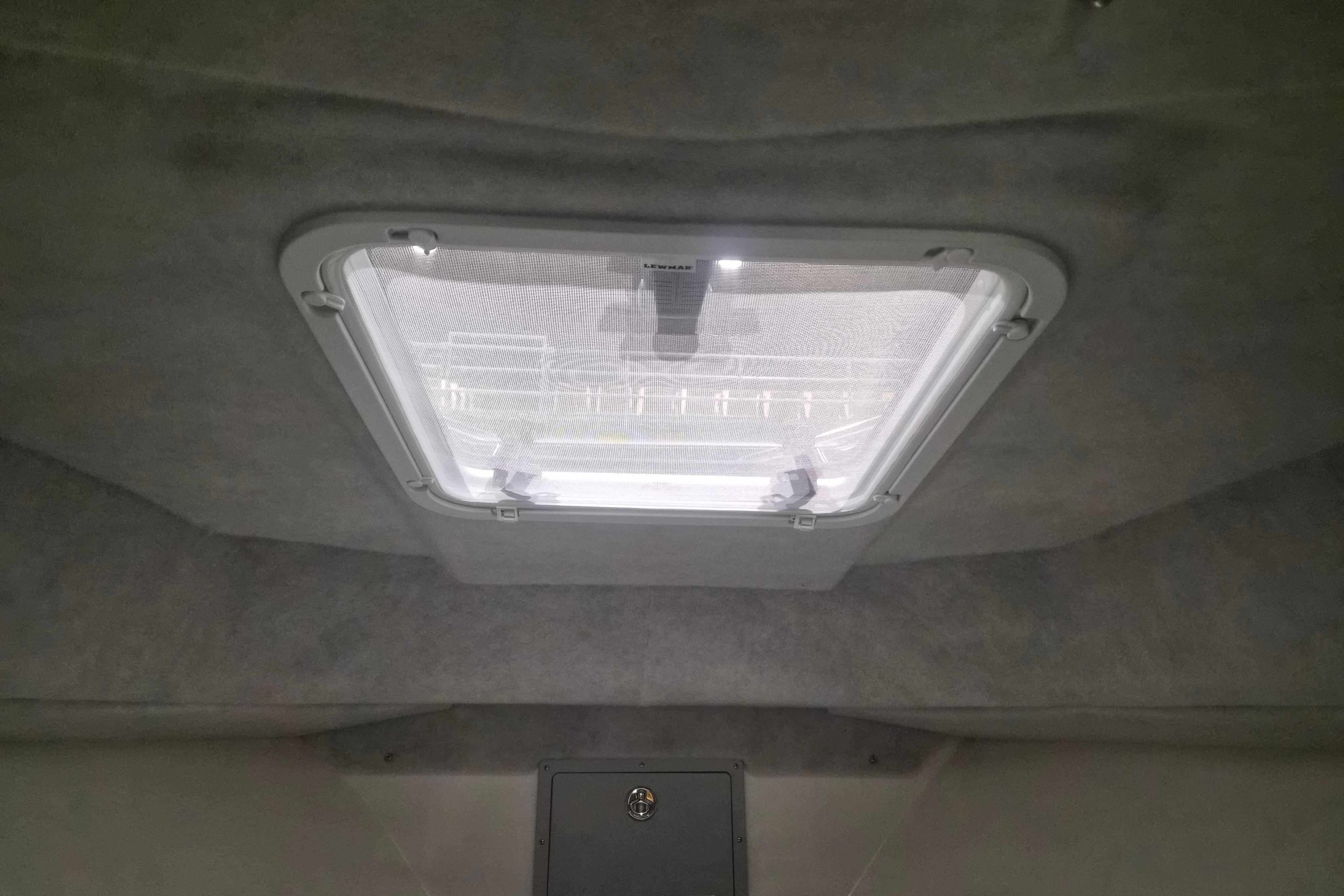Interior view of 2026 Defiance Admiral 260 EX boat cabin with overhead hatch.