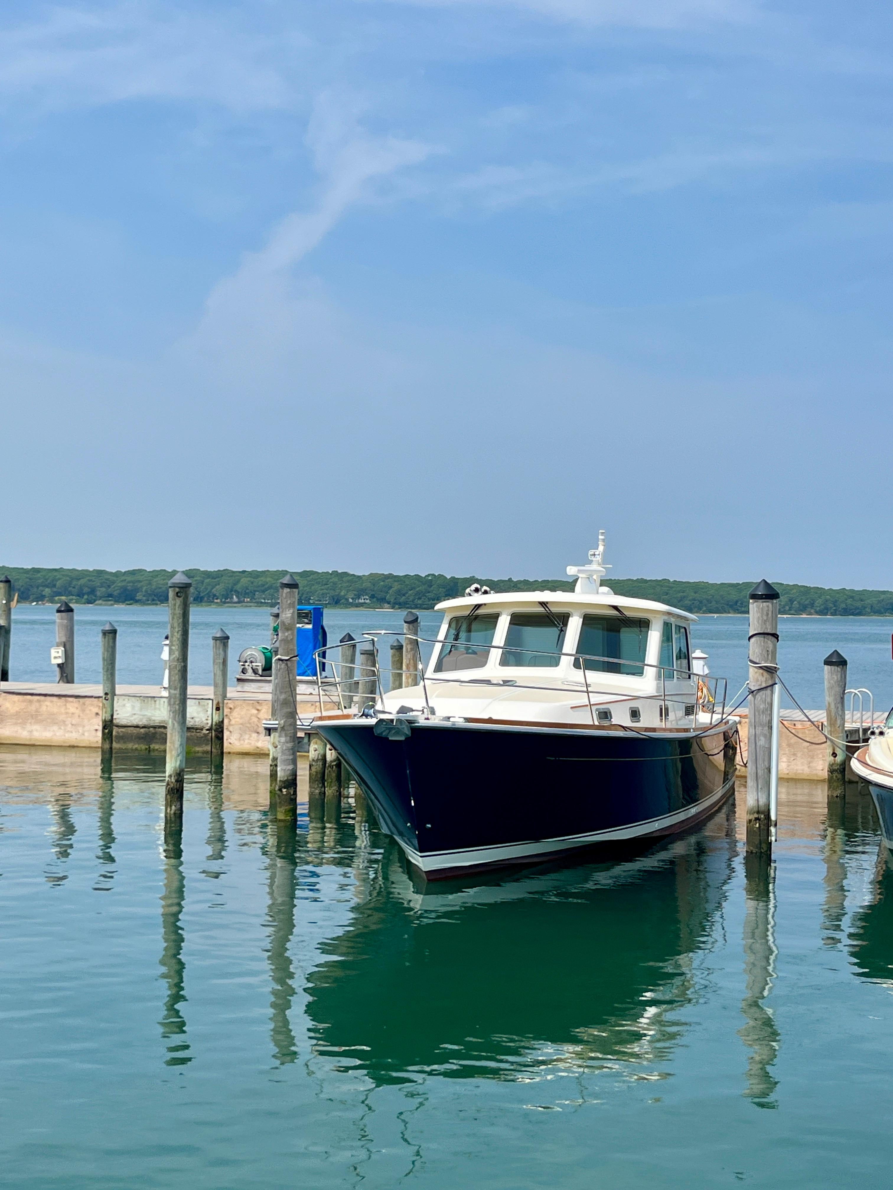 2010 Sabre 40 Sedan docked at a marina on a sunny day.