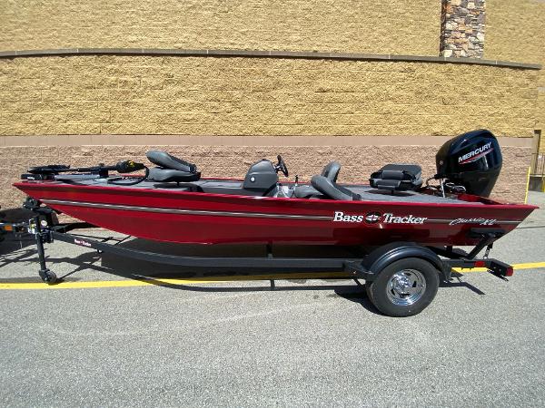 2025 Tracker Bass Tracker Classic XL boat, red, on trailer, parked outdoors.