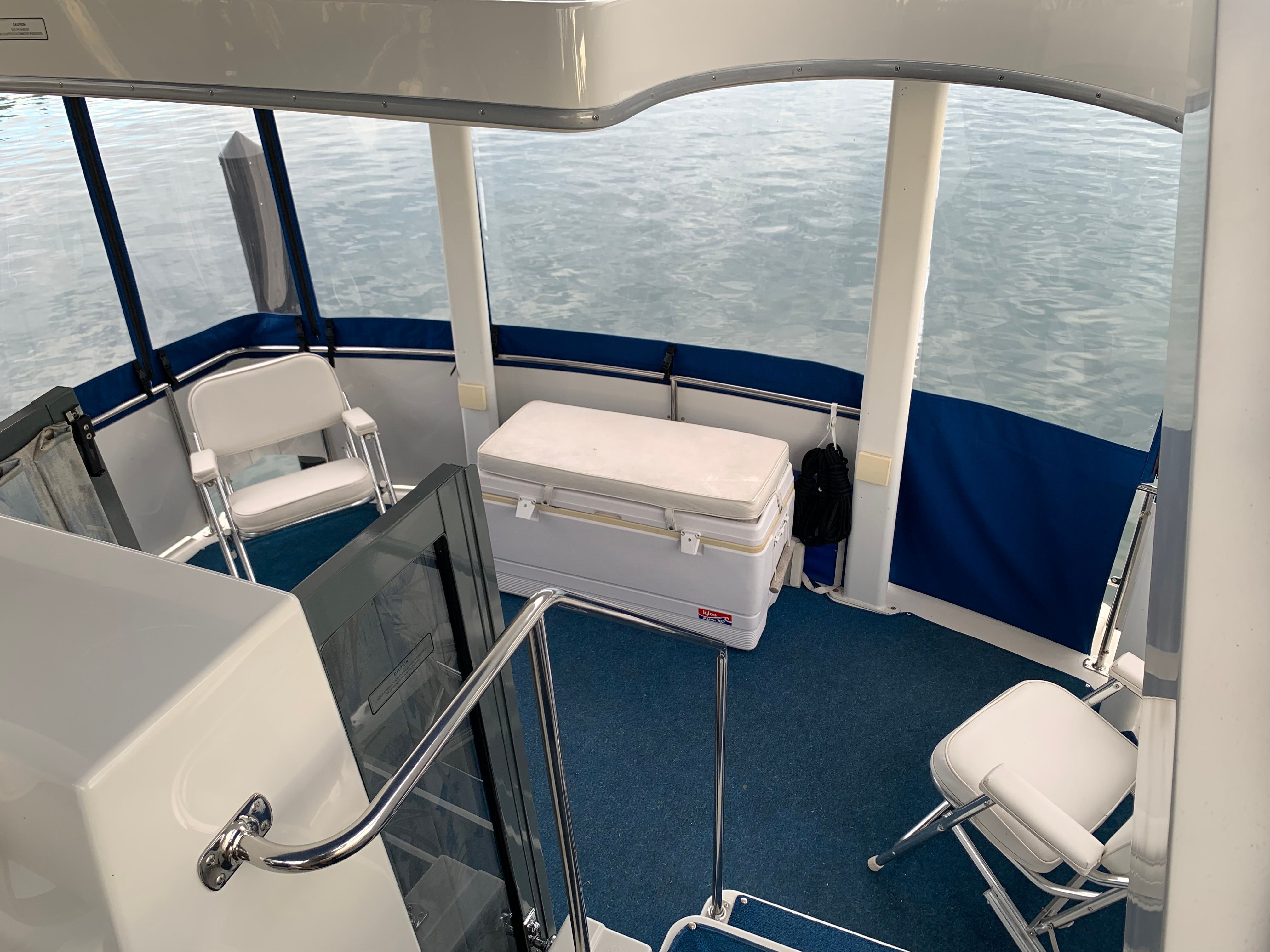 The image shows the cockpit of a 1994 Carver 430 Cockpit Motor Yacht with blue upholstery.