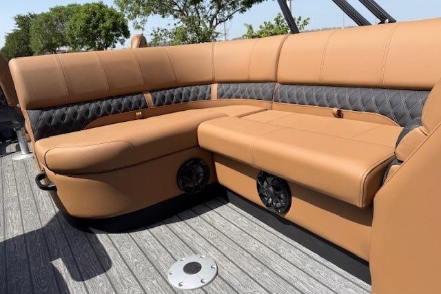 Luxurious seating on 2026 Ranger 223F boat with tan upholstery and built-in speakers.
