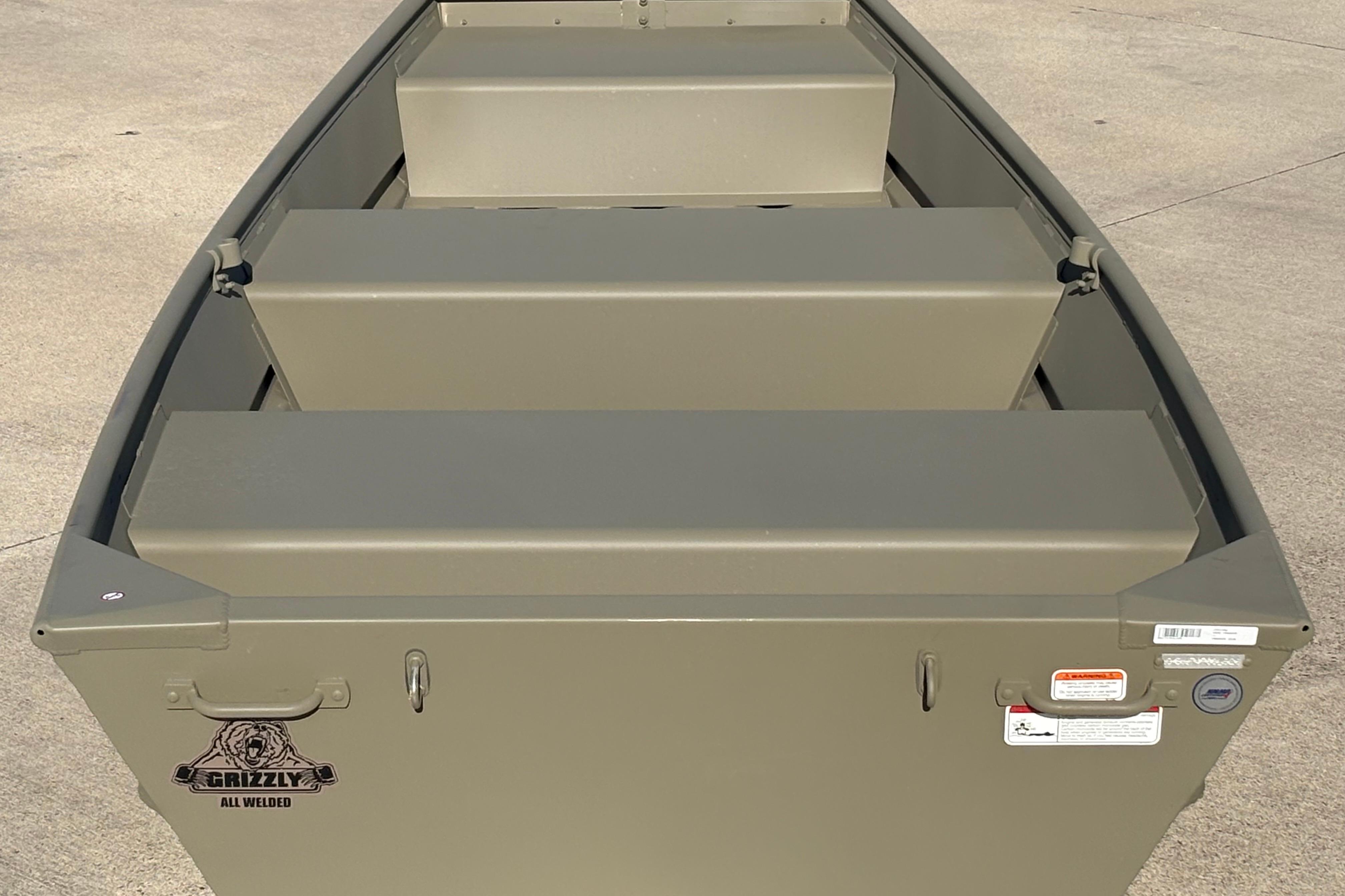 2026 Tracker Grizzly 10 Jon boat, all-welded design, viewed from above on concrete surface.