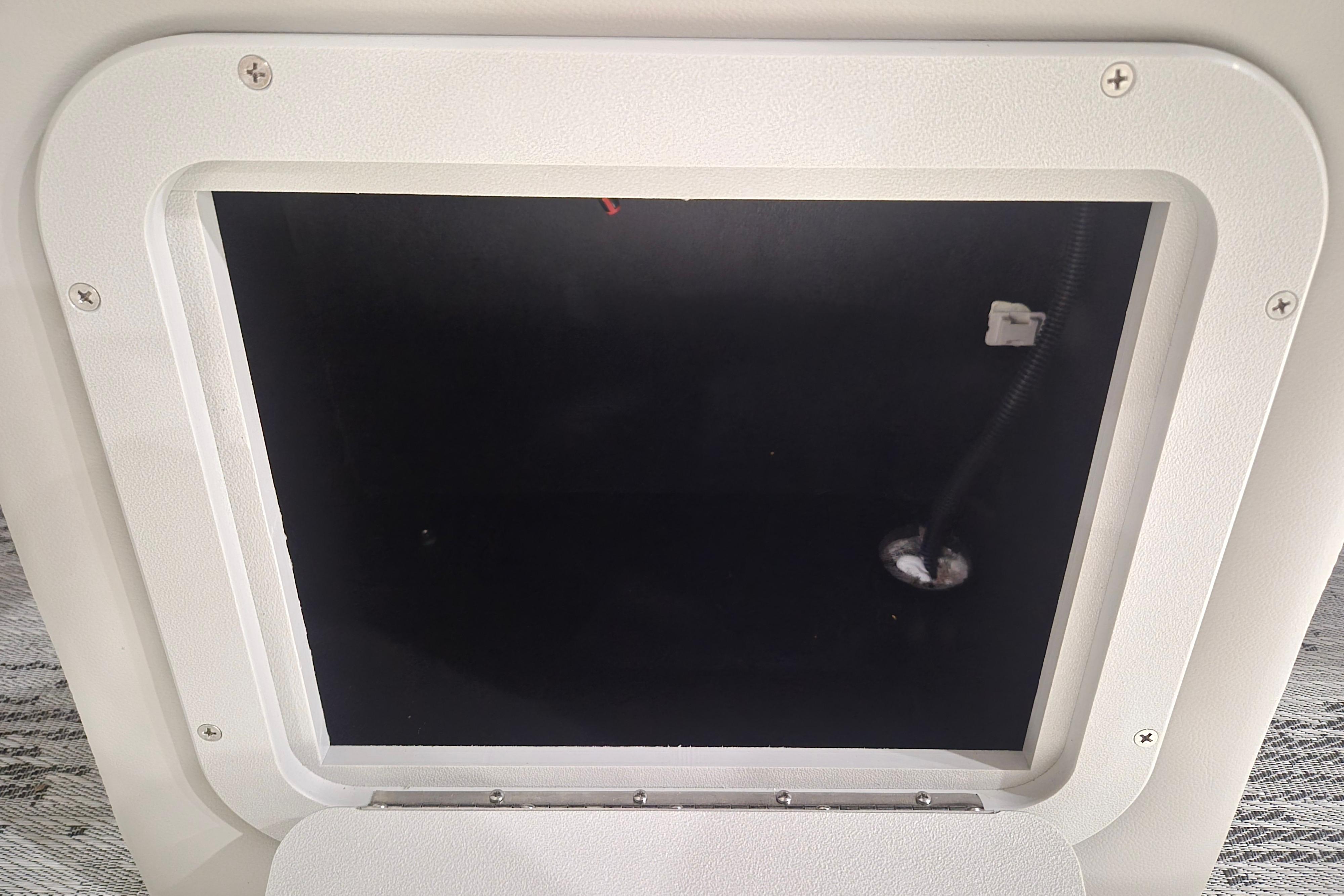 Hatch opening of 2026 Sylvan R-22 LZ DH boat, showcasing interior compartment.
