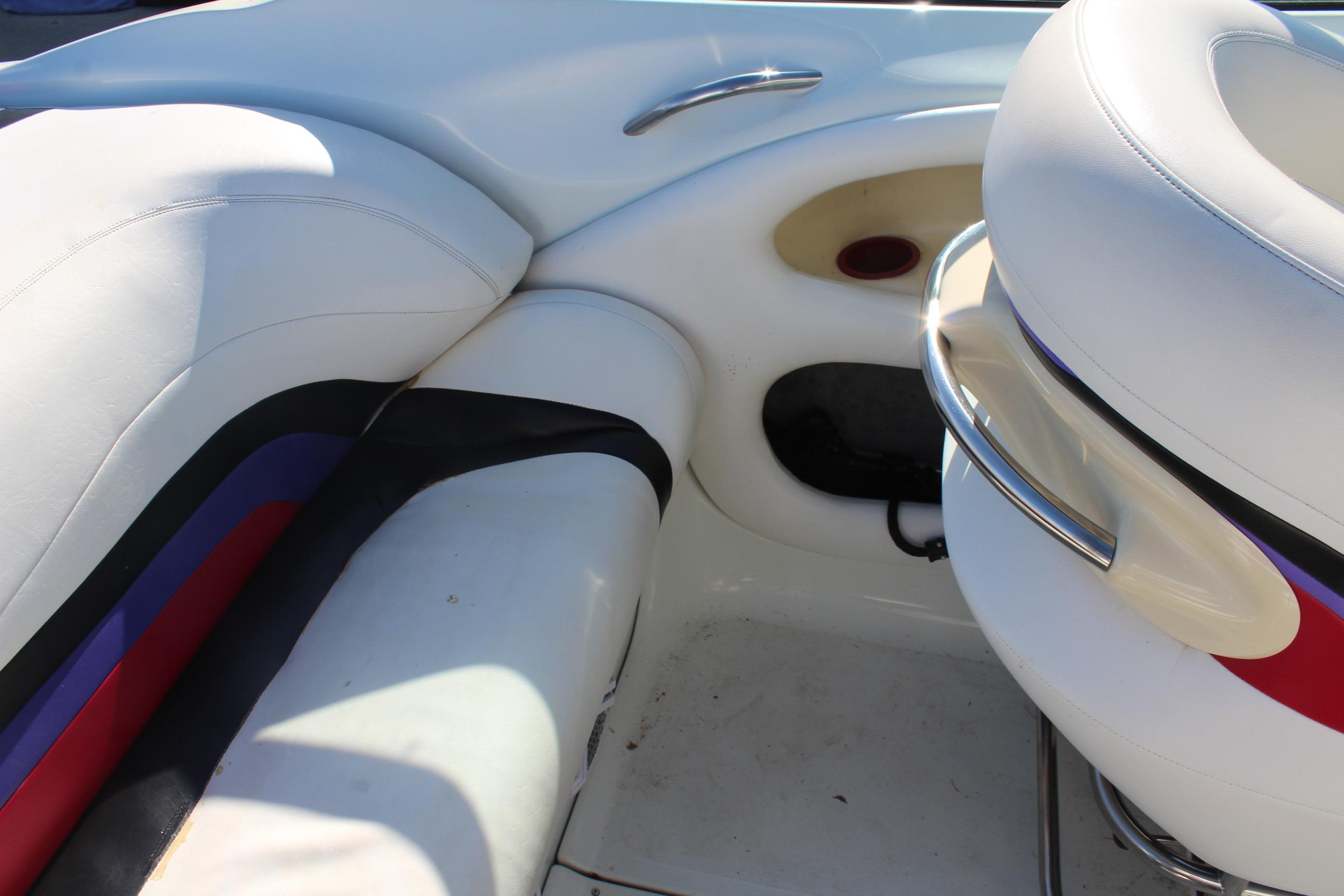 Interior of a 1996 Baja 232 boat featuring white and multicolored seating.