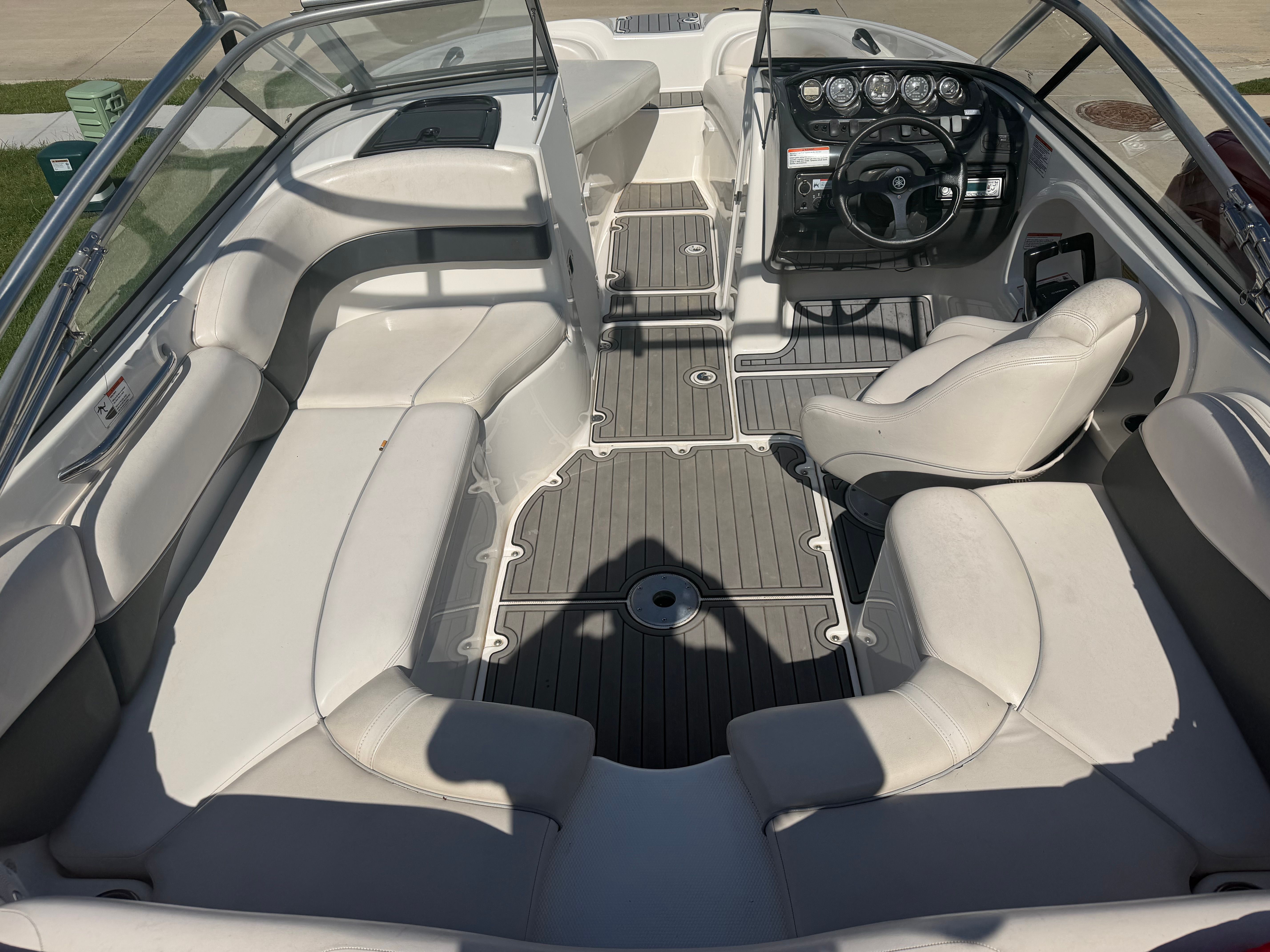 Interior of a 2006 Yamaha AR210 boat with white seating.