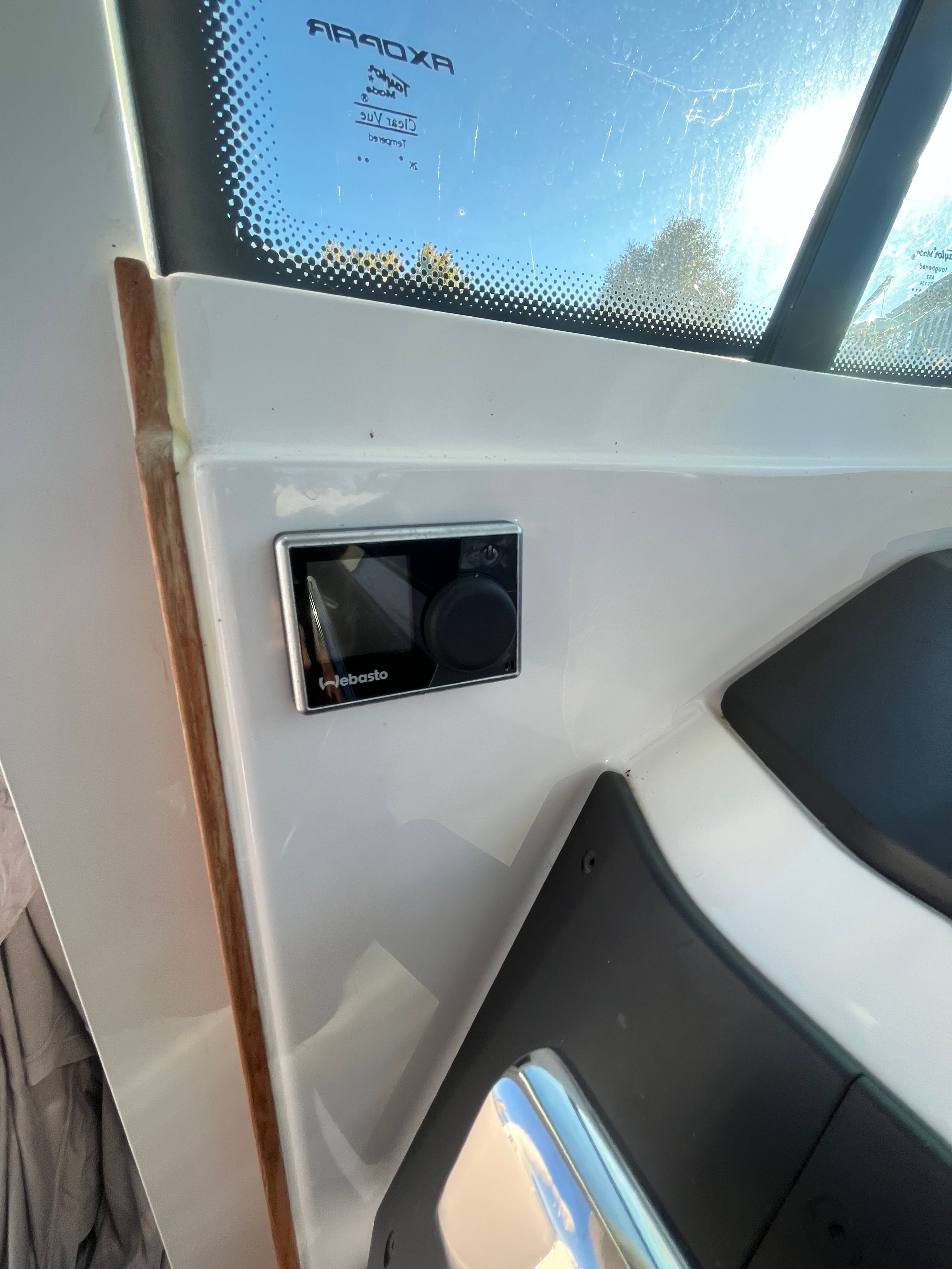 Close-up of a control panel inside the cabin of an Axopar 28 Cabin boat.