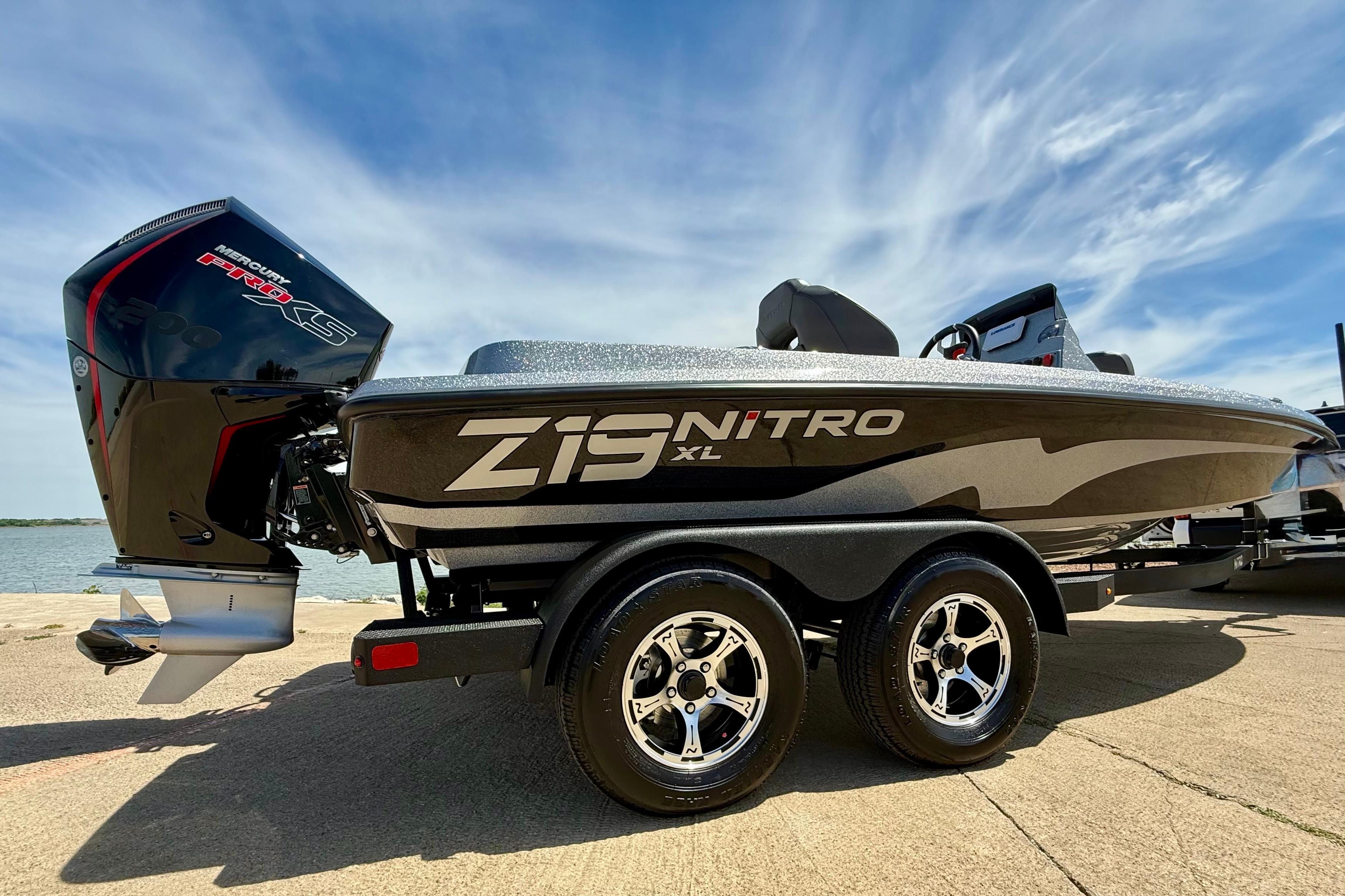 2026 Nitro Z19 XL boat with Mercury Pro XS engine, parked by the water under a clear sky.