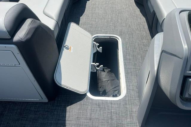 Open storage compartment on 2026 Godfrey Sweetwater 2286 SBC boat interior.