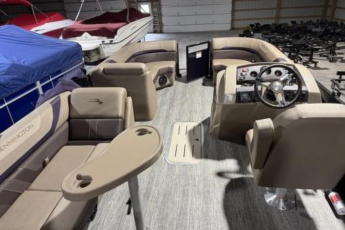 2026 Bennington 22SXSB pontoon boat interior with beige seating and steering console.