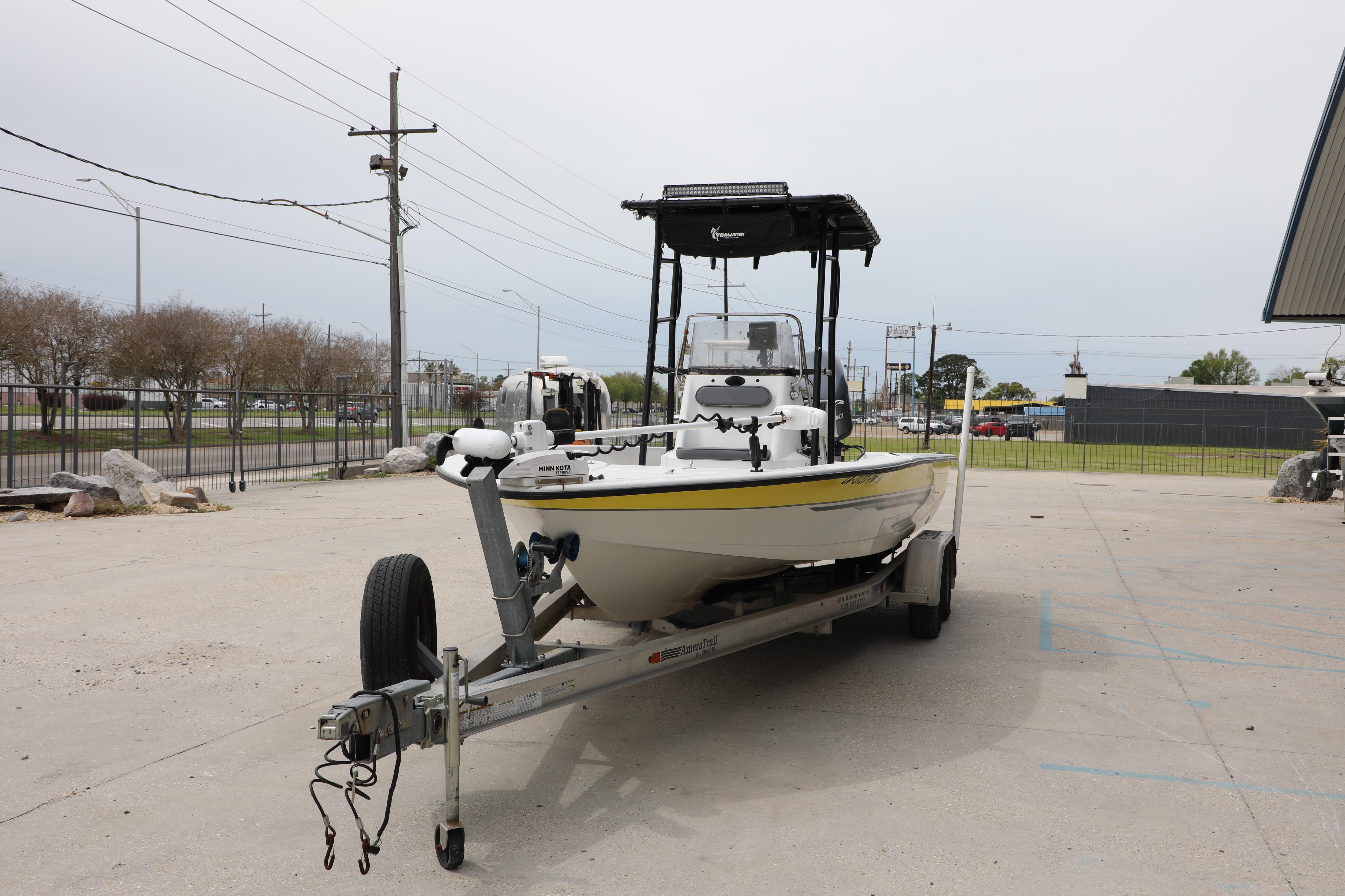 2002 Ranger 2300 Bay Ranger boat on trailer in parking lot.