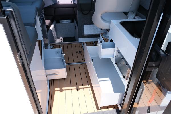 2023 Makaira Gen3 800 interior with open storage drawers and wood flooring.