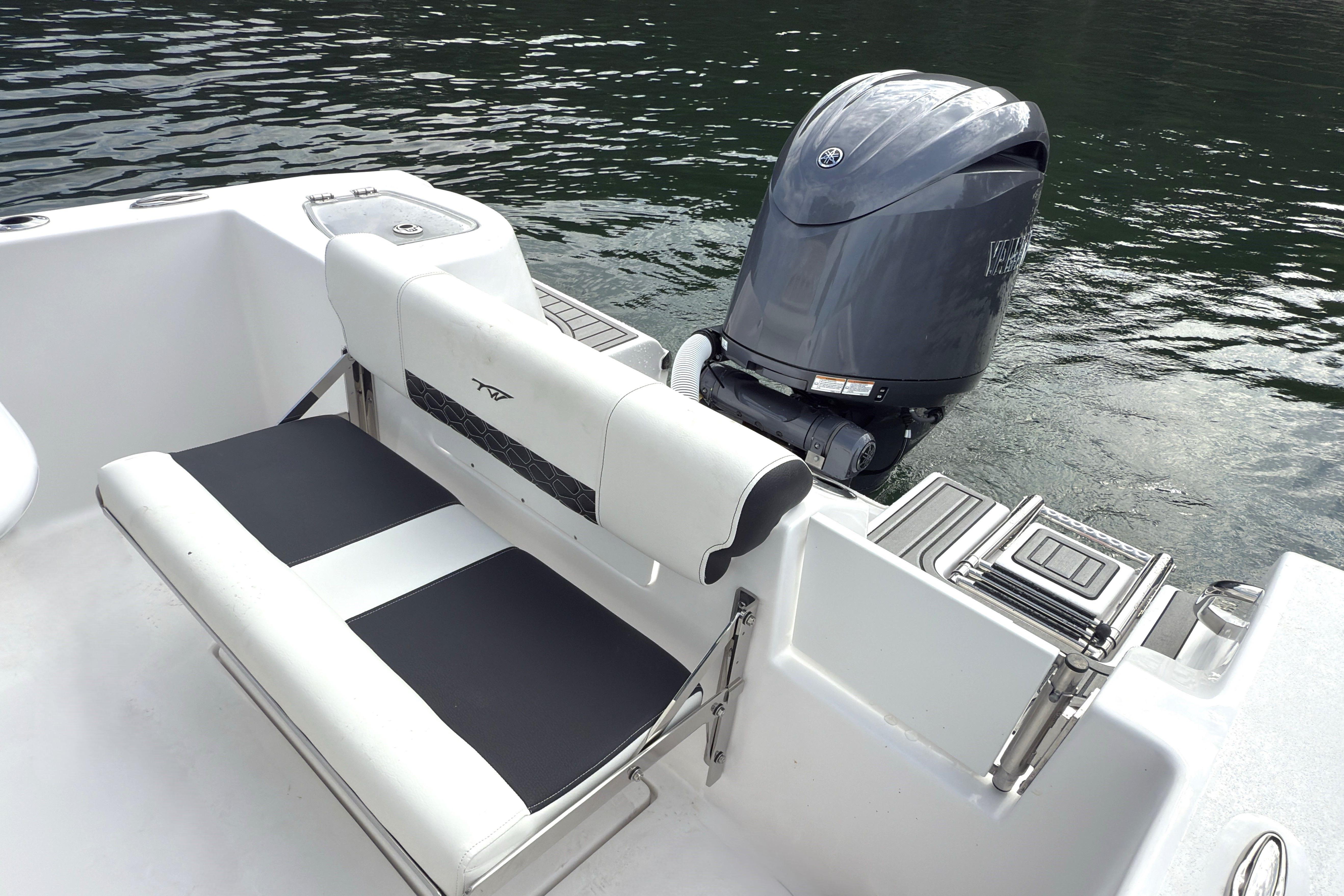 2026 Tidewater 210 CC Adventure boat with Yamaha outboard motor on calm water.