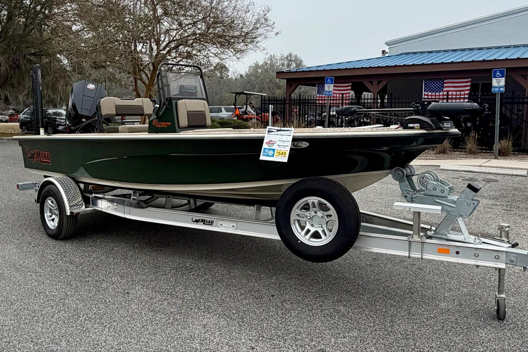 2025 Mako 18 Pro Skiff Backwater Edition on trailer, parked outdoors.