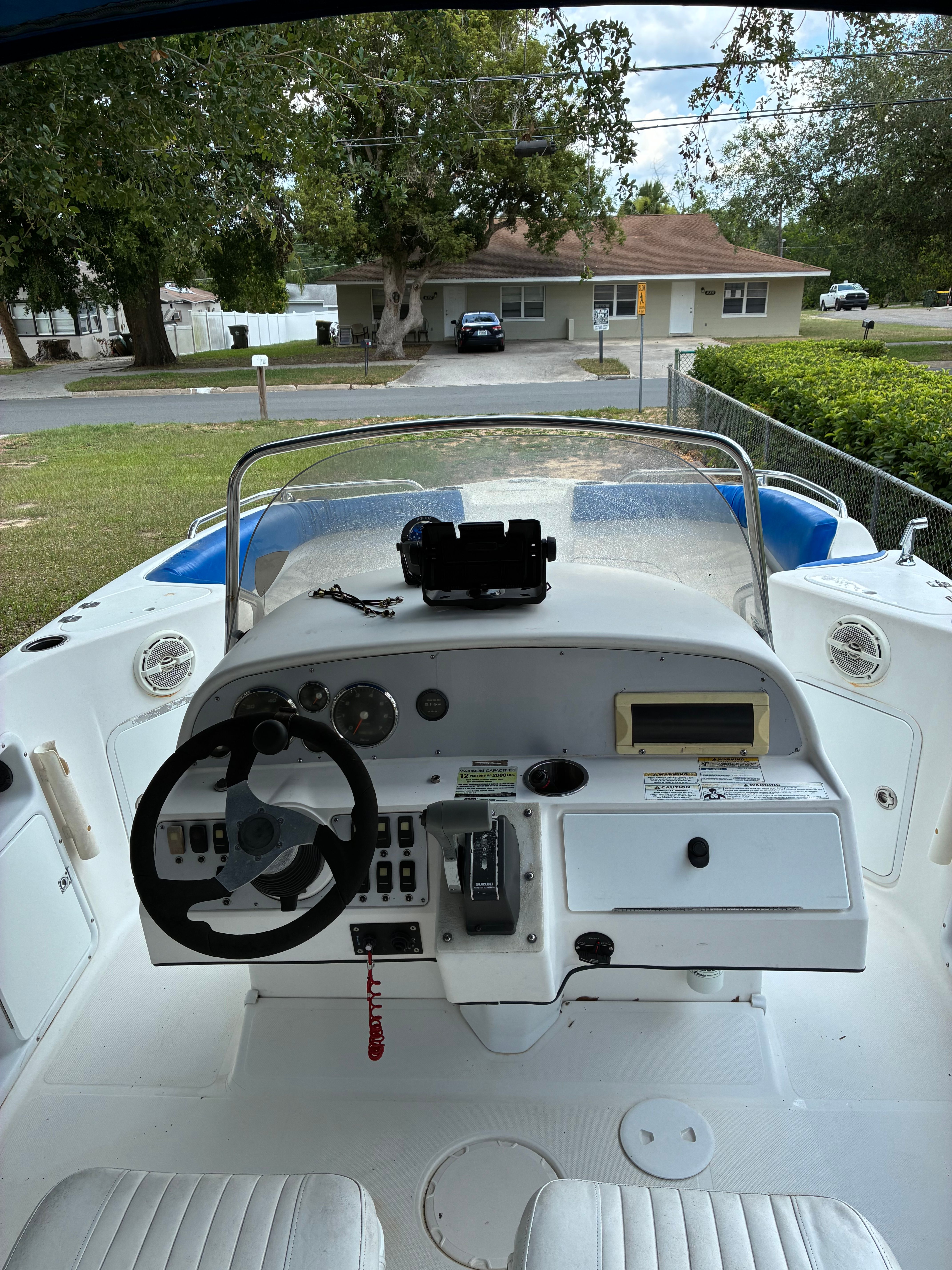 The image shows the cockpit of a 2012 Hurricane SunDeck Sport 231 OB. It is parked on land.