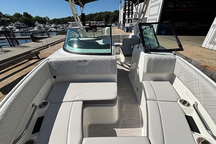 2027 Sea Ray SDX 230 Outboard boat interior with luxurious seating at marina.