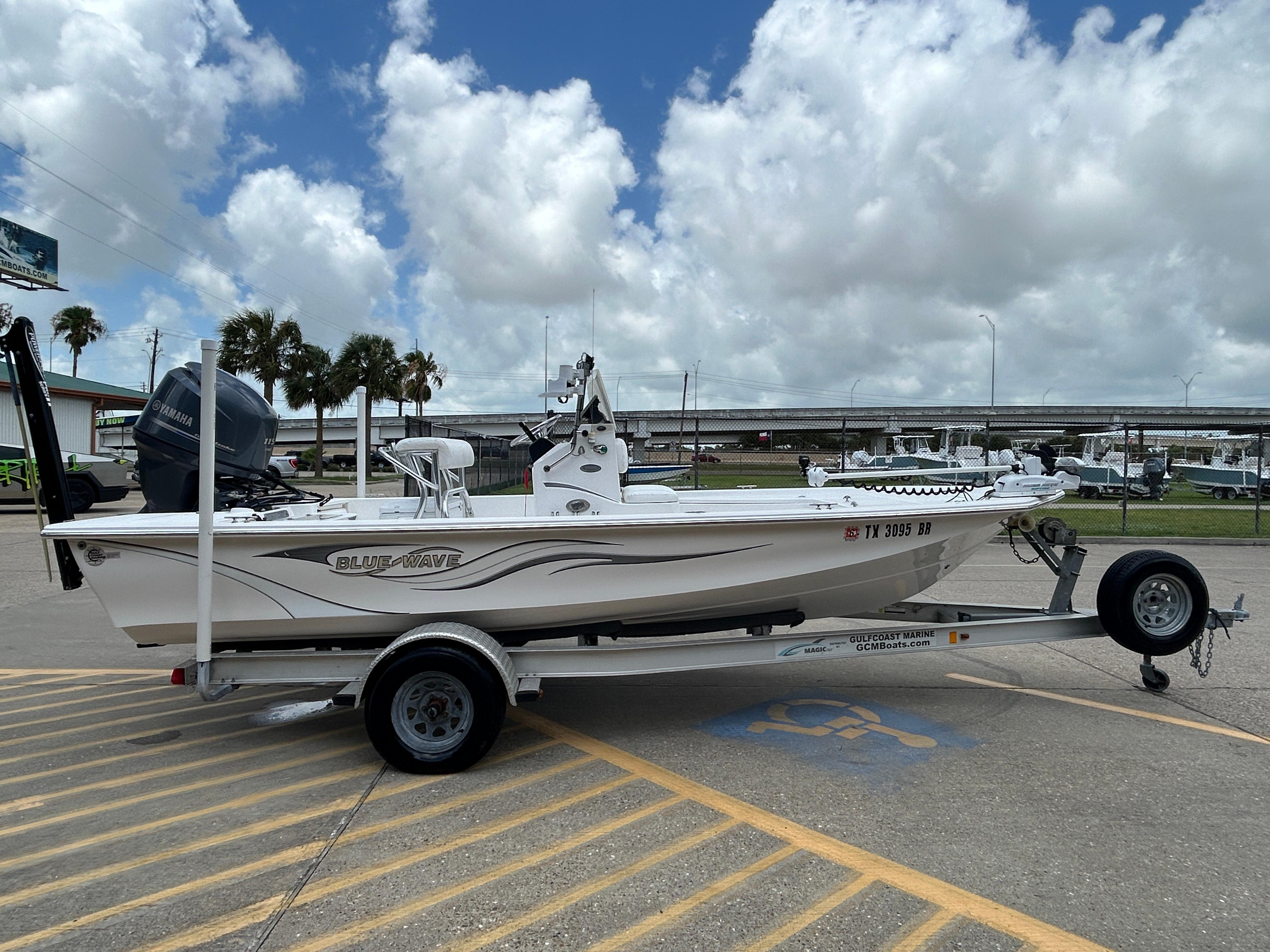 2012 Blue Wave 1900 STL boat on trailer, parked outdoors under cloudy sky.