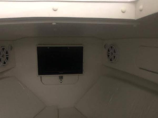 Interior of 2019 Midnight Express 39 Cuddy boat with TV and speakers.