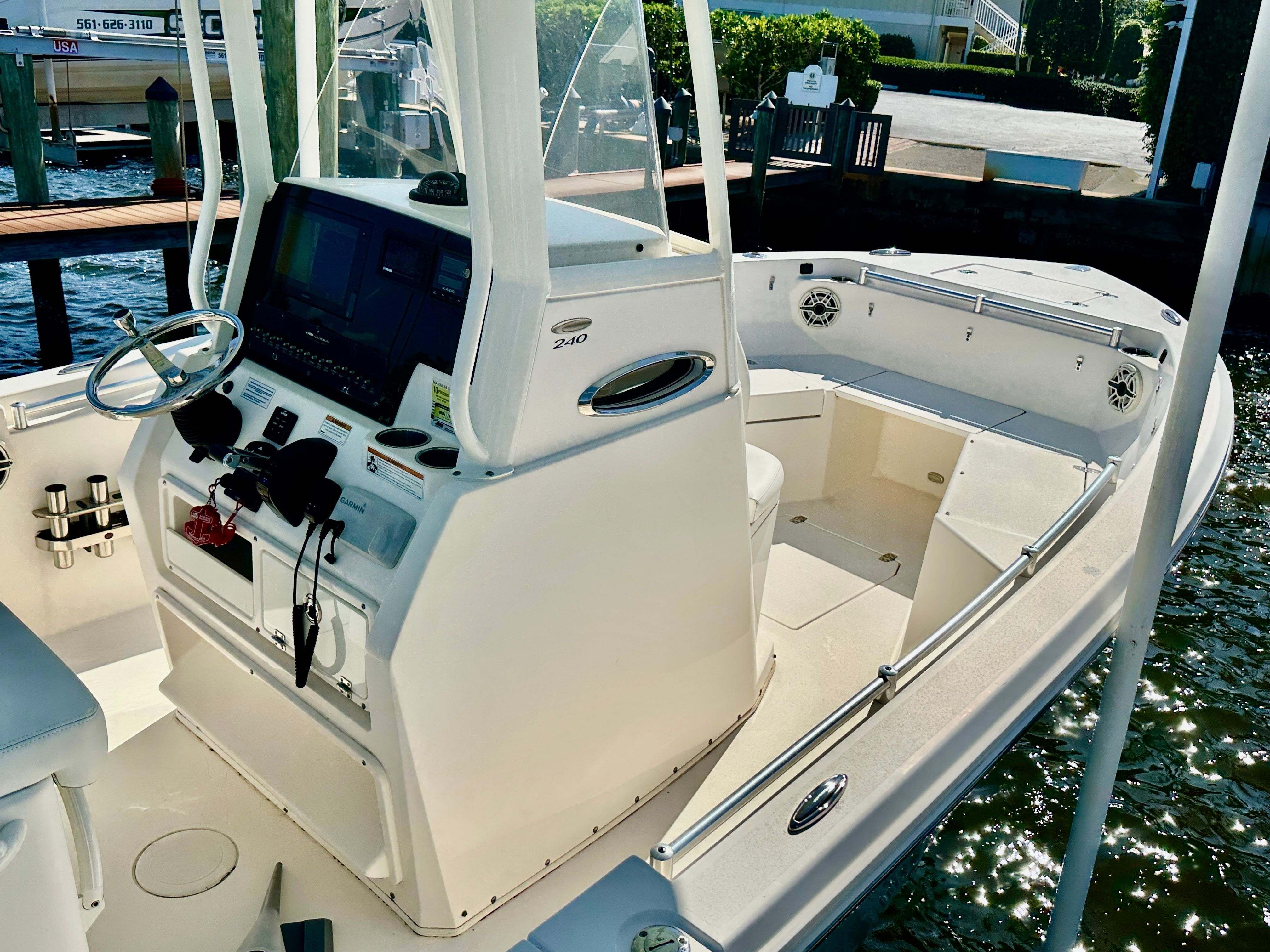 The image shows a 2022 Cobia 240 Center Console boat at a dock.