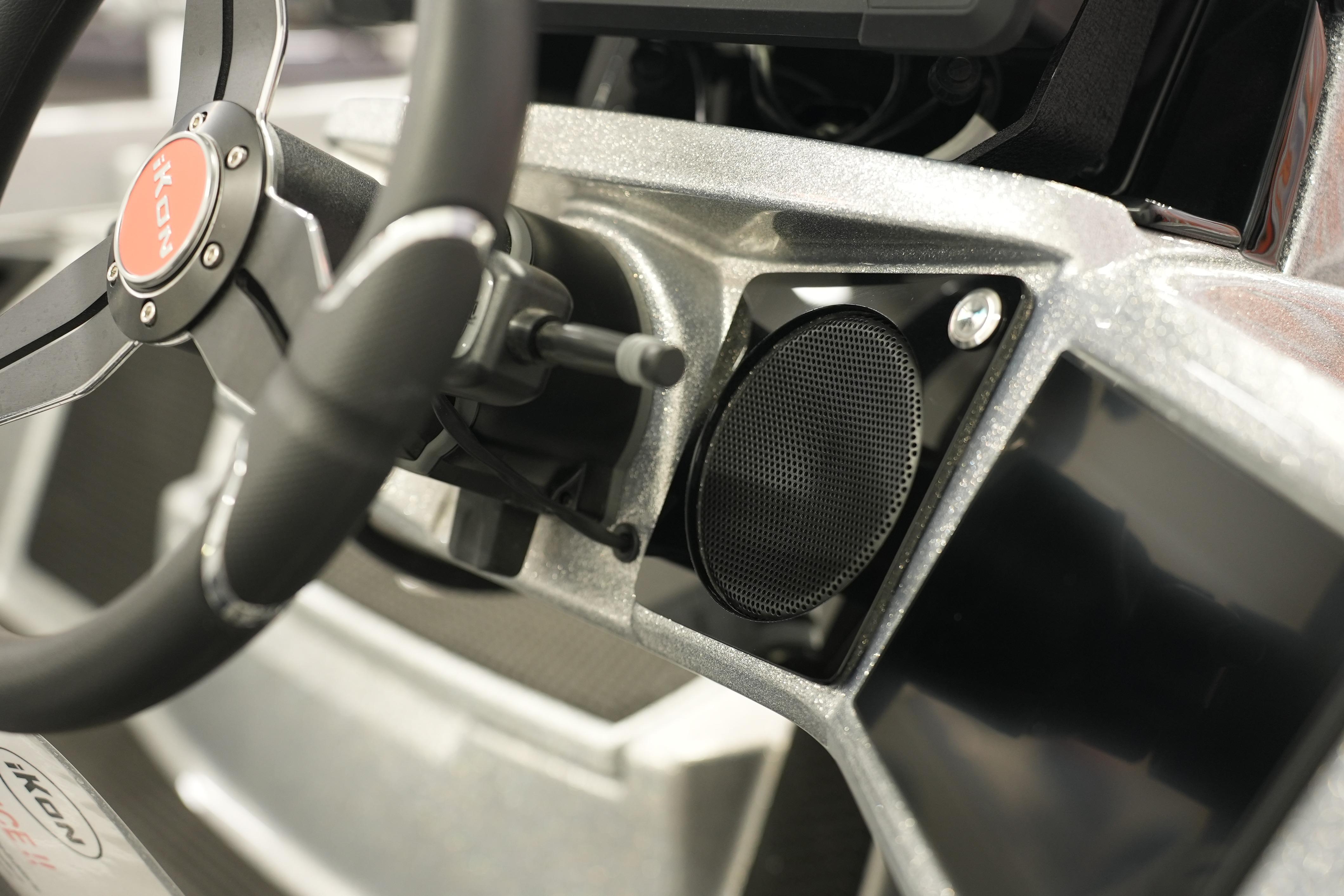 Steering wheel and dashboard of 2026 iKon LXE20 vehicle interior.