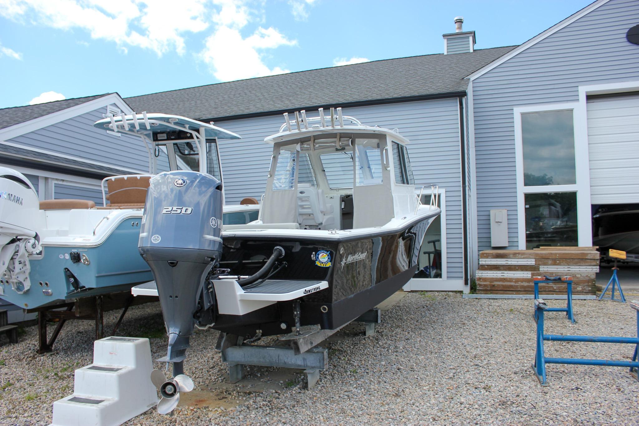 2022 NorthCoast 235 Cabin boat with Yamaha 250 engine, displayed outdoors.