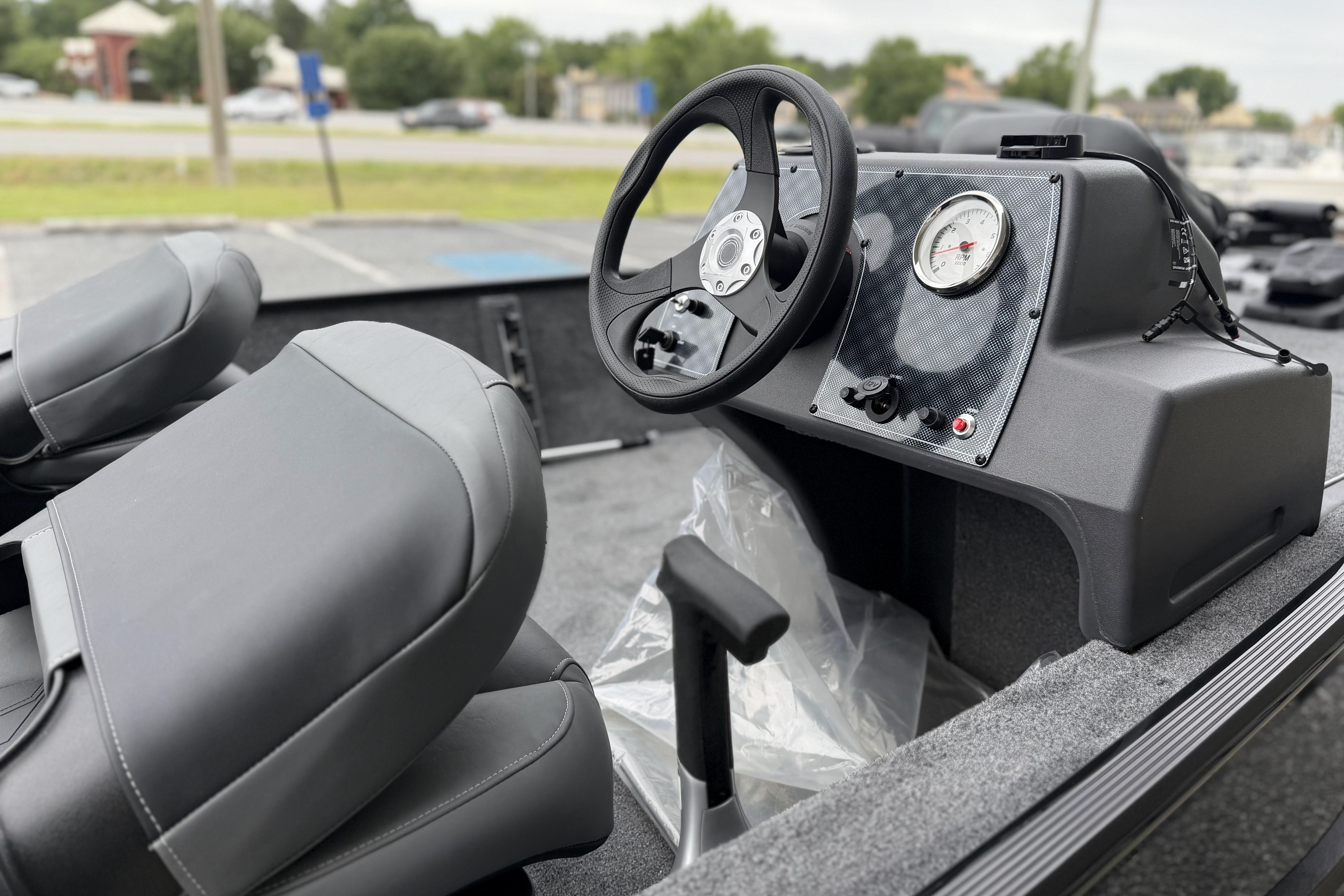 2026 Tracker Bass Tracker Classic XL boat interior with steering wheel and dashboard controls.