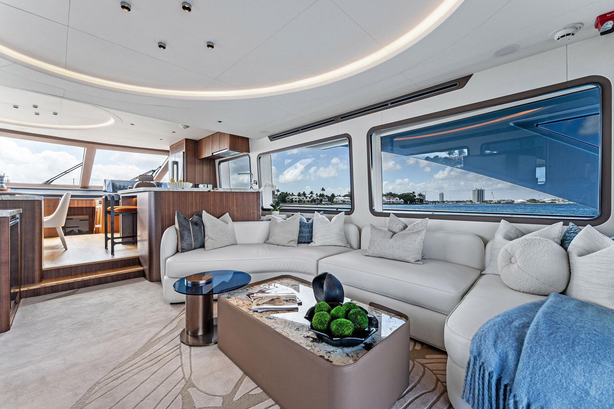 Luxurious interior of 2024 Aquitalia 78 Fly yacht with modern furnishings and large windows.