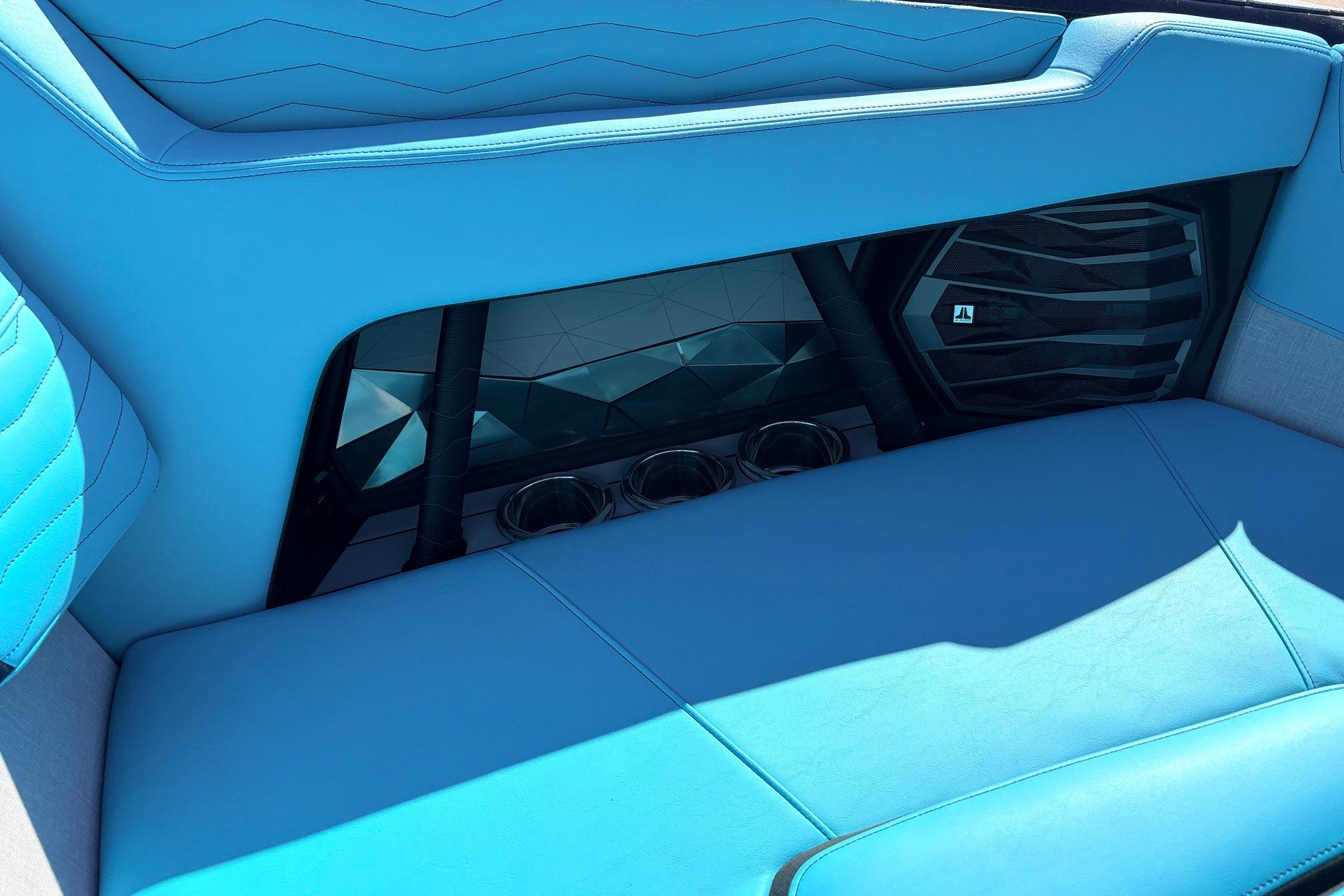 2026 Nautique Super Air Nautique G23 interior with blue seating and speaker system.