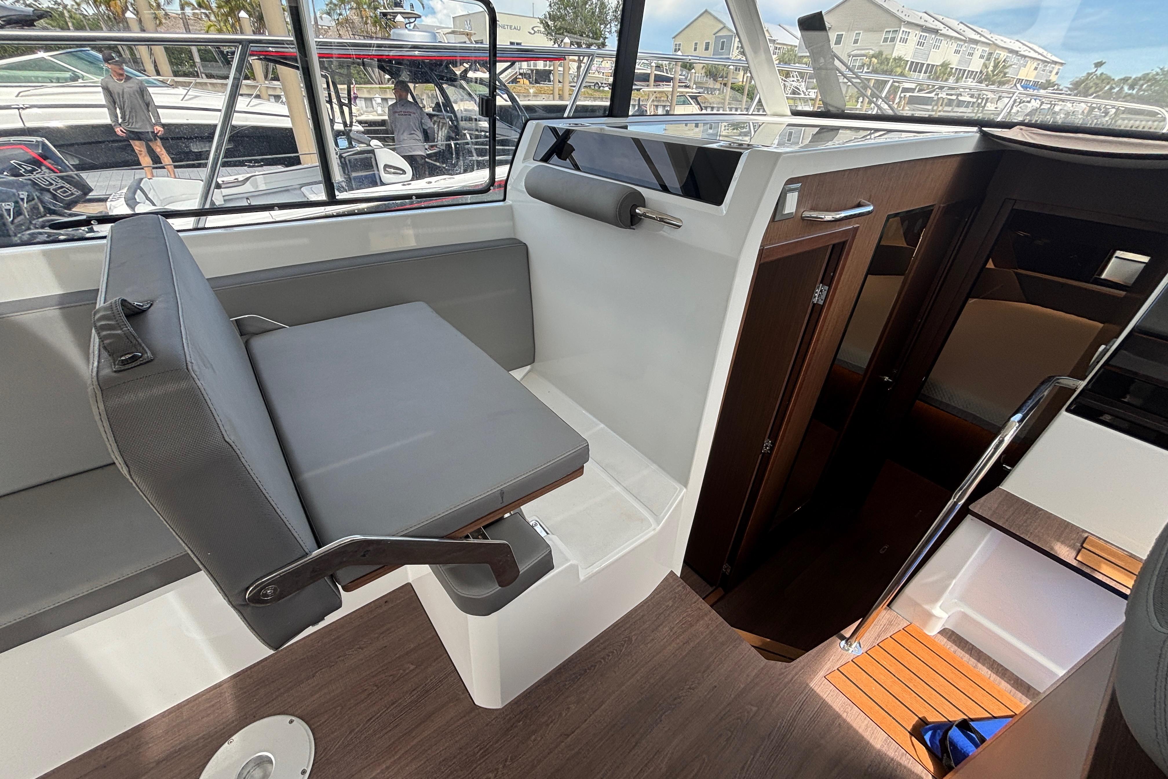 Interior of 2024 Beneteau Antares 11, featuring seating and cabin entrance.