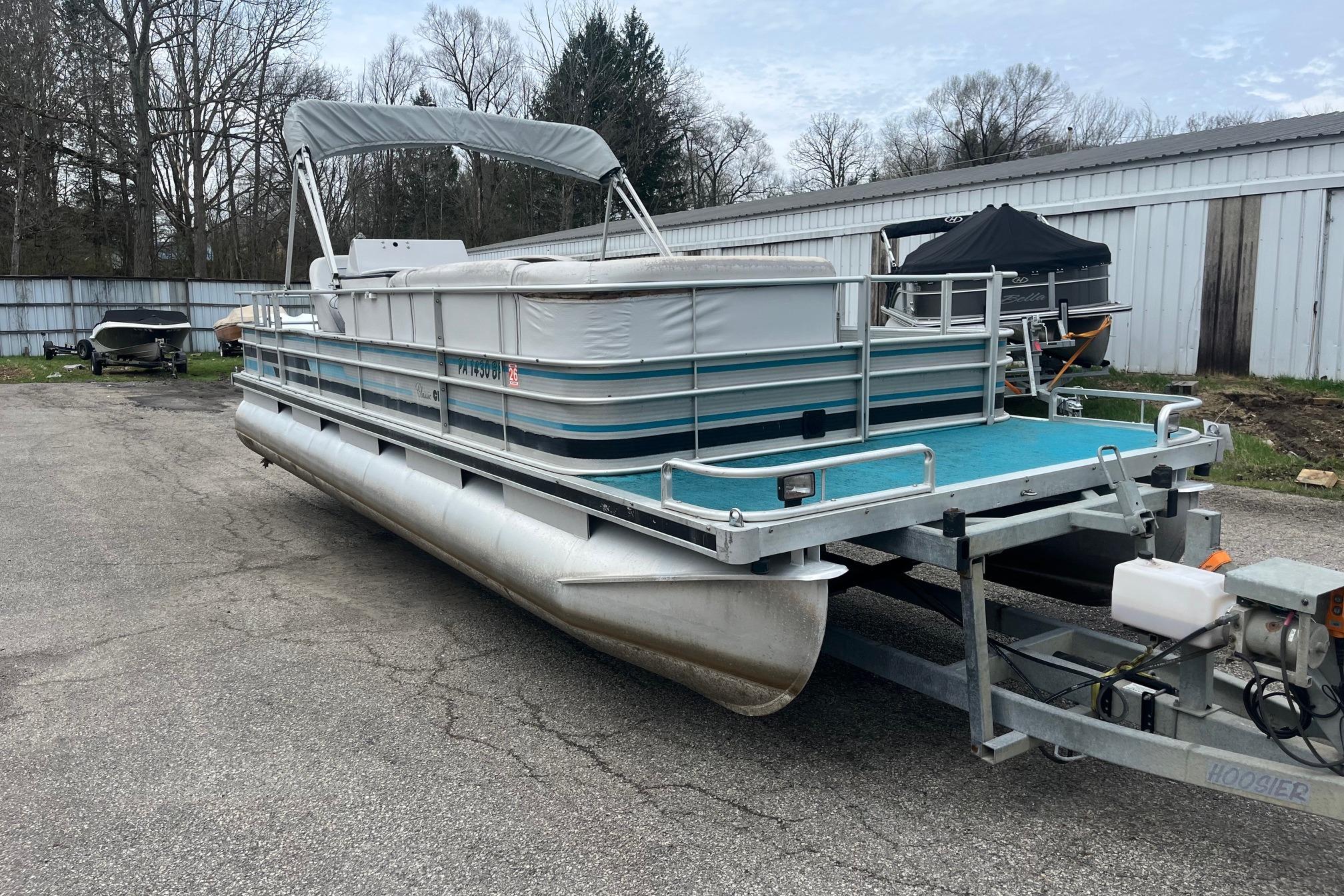 1992 Harris FloteBote 240 Classic pontoon boat on trailer, parked outdoors.