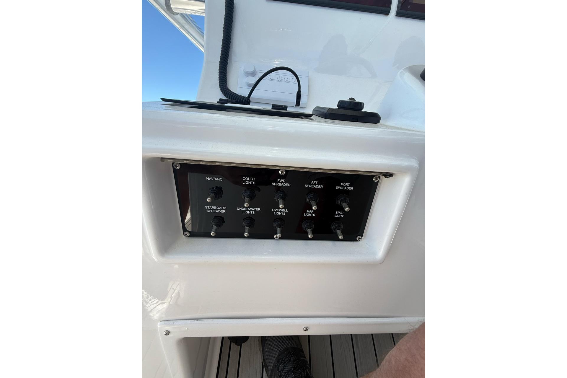 Control panel on a 2021 Custom Infusion 34 CC boat, featuring various light switches.