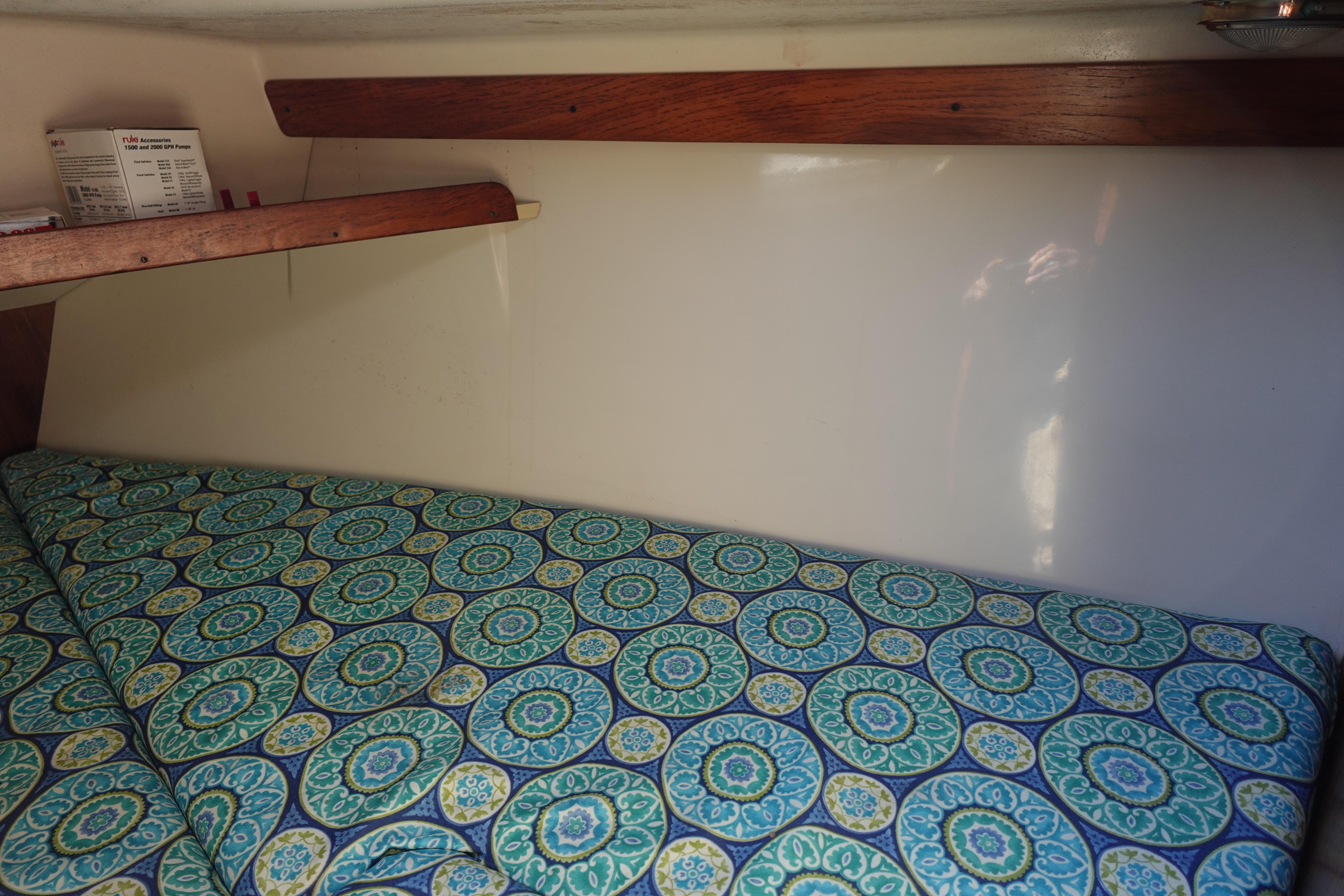 Cozy cabin interior of 1997 Catalina 28 sailboat with patterned bedding.