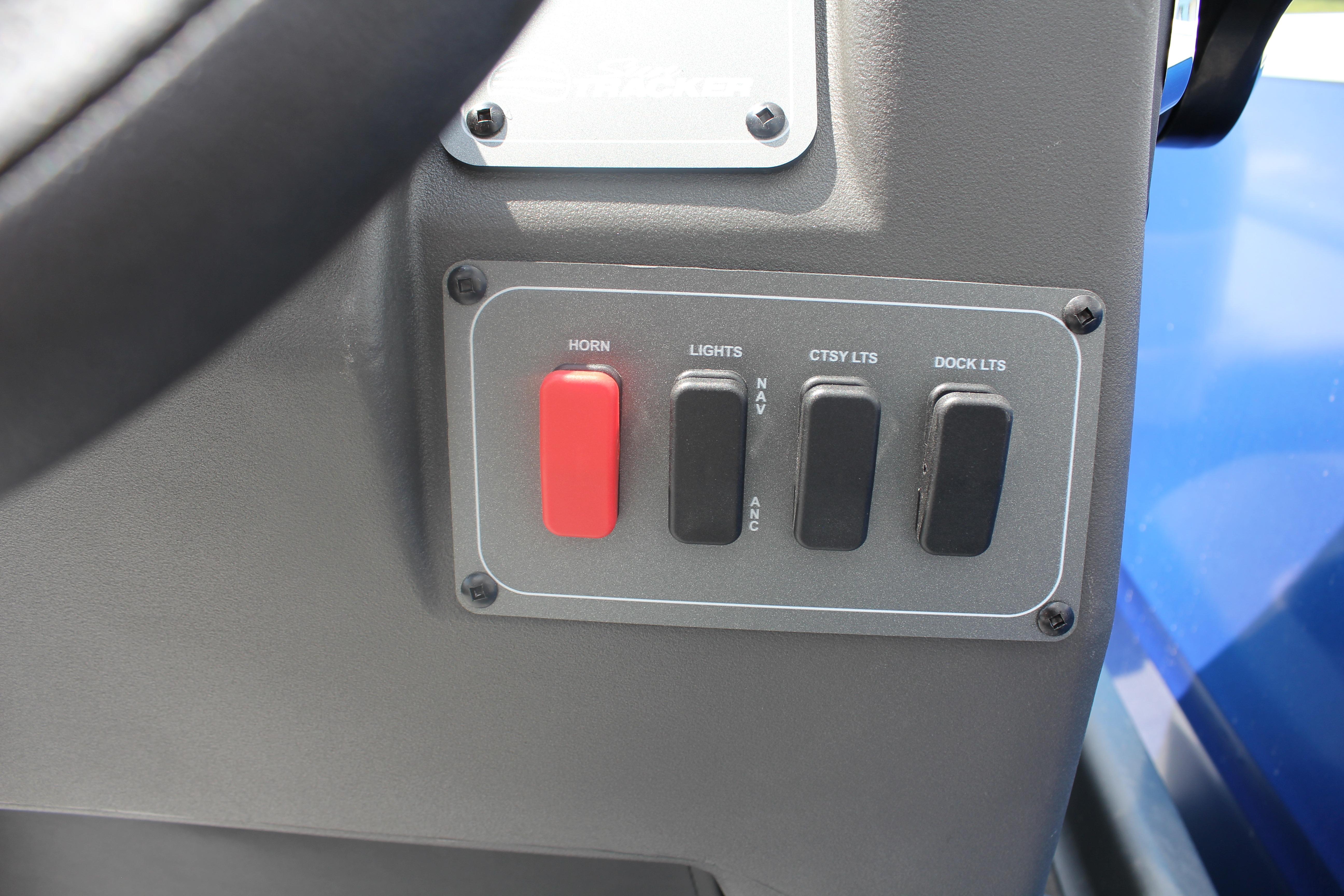 Control panel of 2026 Sun Tracker Party Barge 16 DLX with switches for horn and lights.