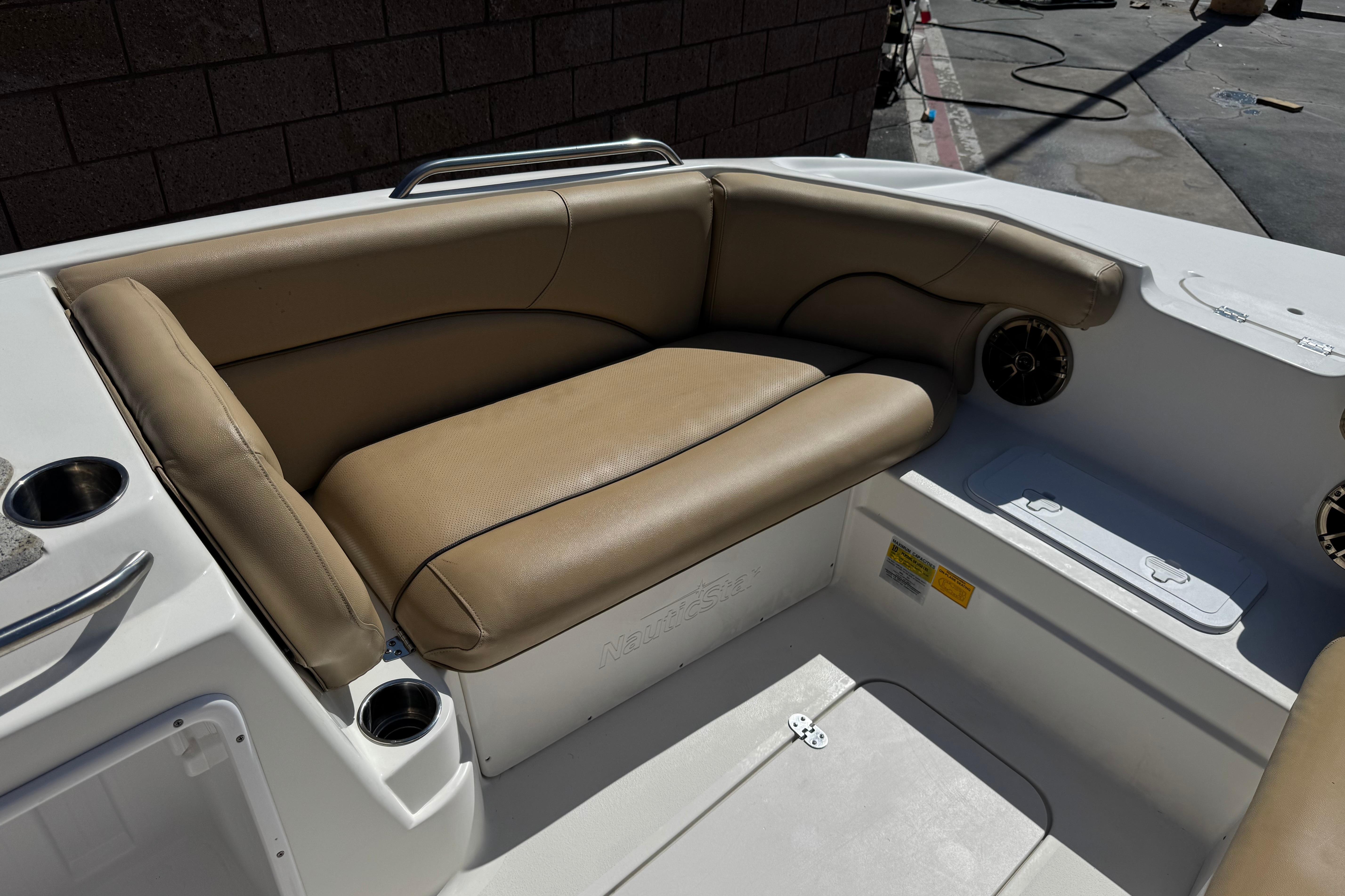 2020 NauticStar 203 SC boat interior with tan seating and cup holders.