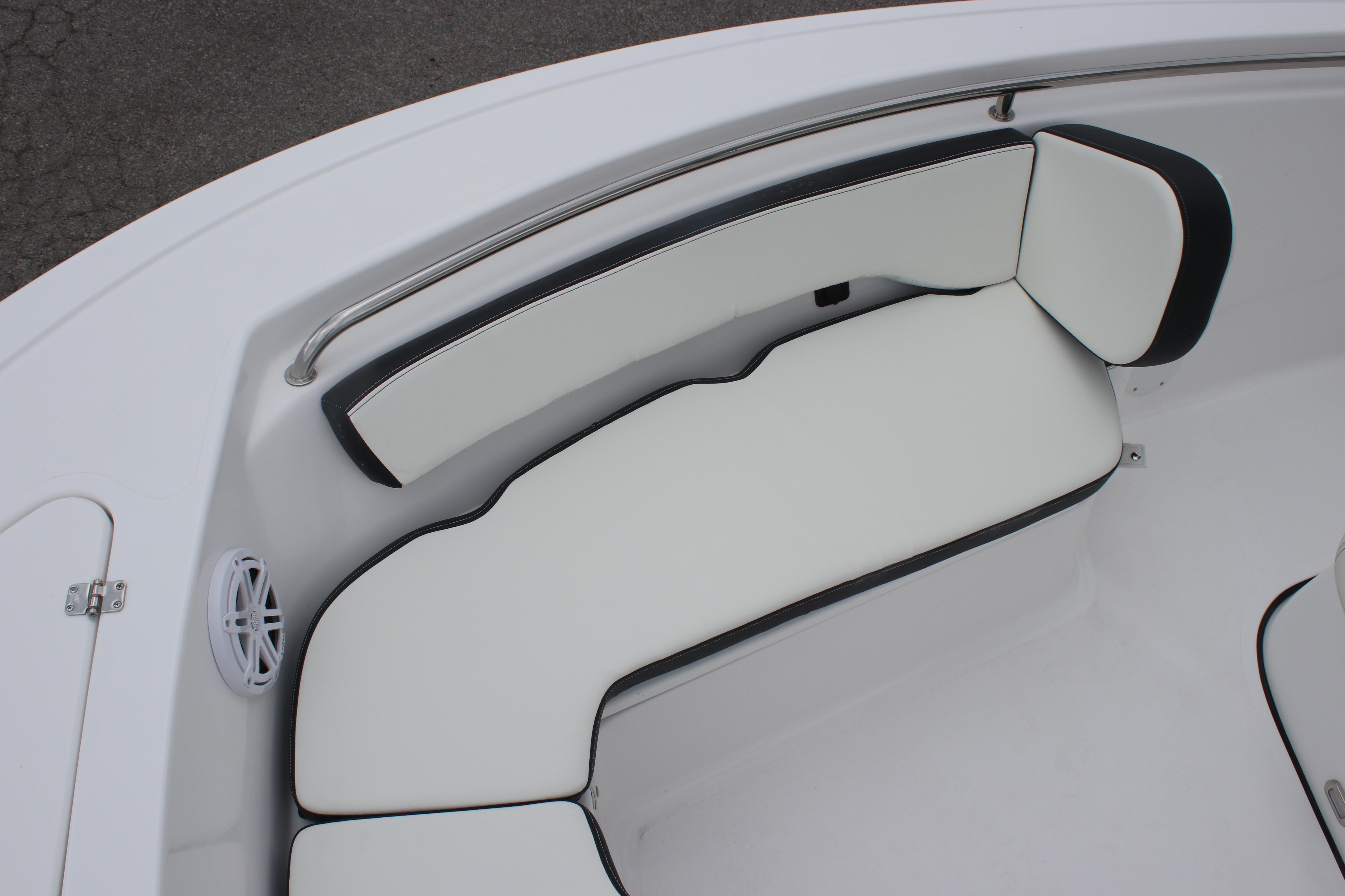 2026 Tidewater 198 CC Adventure boat with white cushioned seating and stainless steel rail.