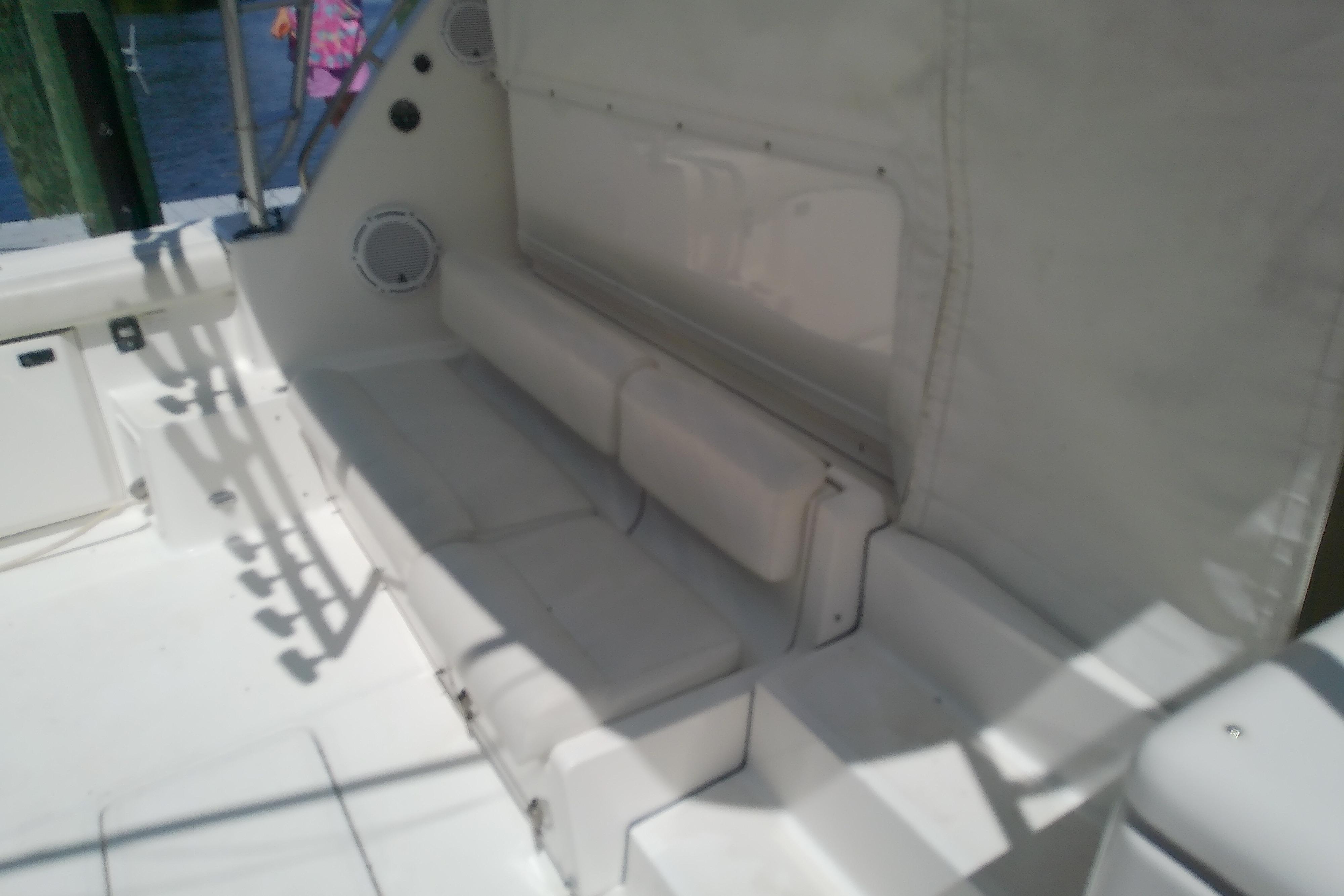 Interior seating area of a 2000 Tiara Yachts 4100 Open, featuring white cushioned benches.