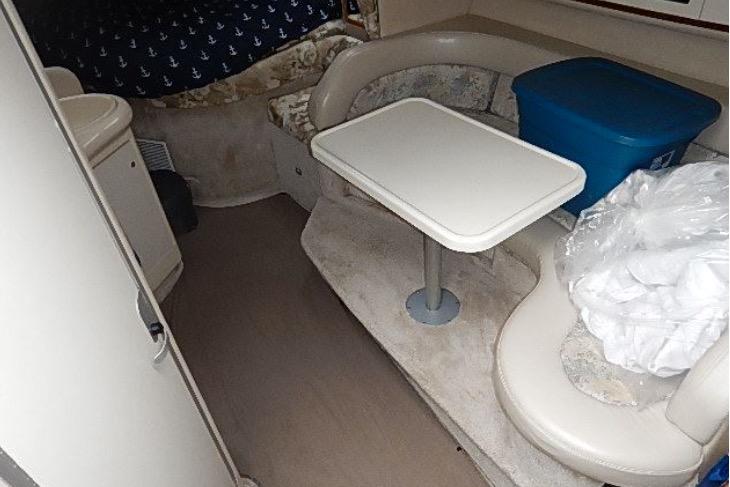 1995 Sea Ray 330 Sundancer cabin interior with seating and table.