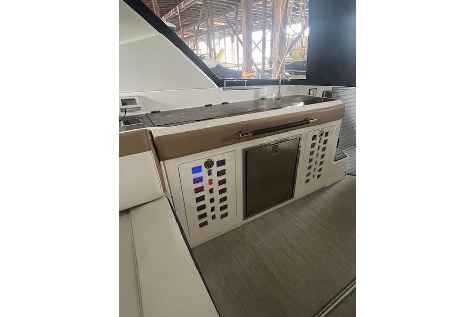2018 Sea Ray SLX 400 yacht interior with control panel and sink area.