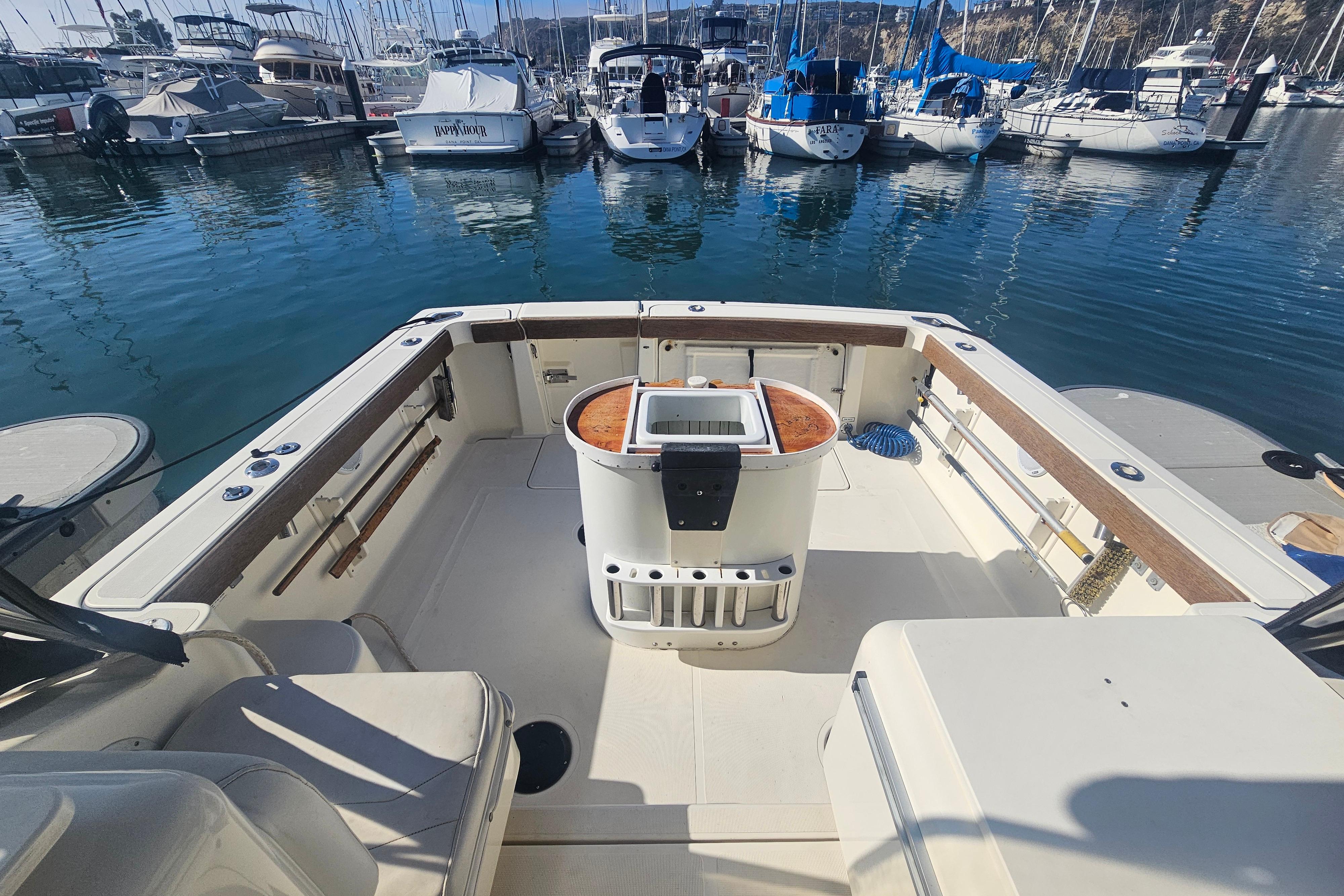 2001 Pursuit 3000 Express boat interior at marina, showcasing spacious deck and seating.