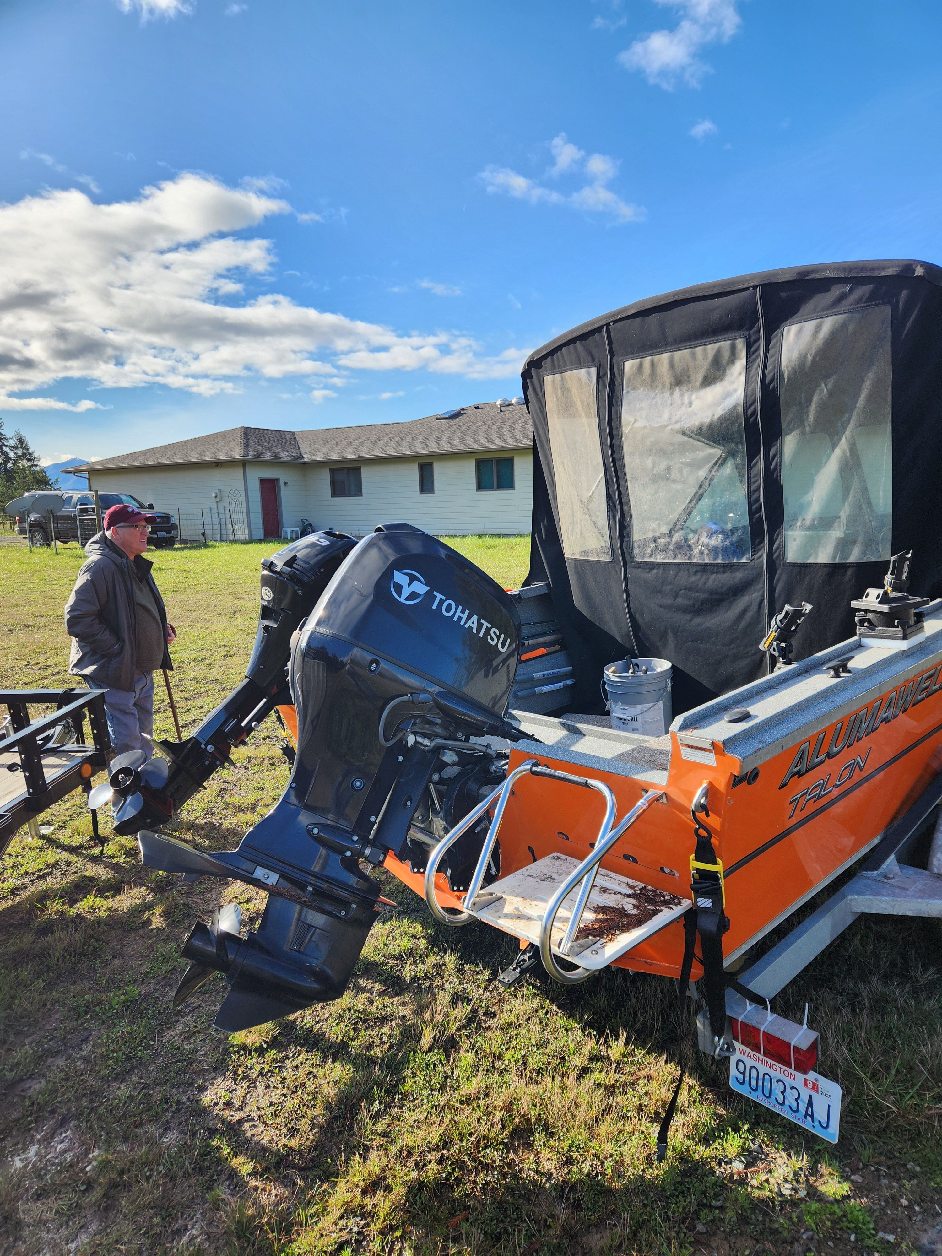 2020 Alumaweld Talon 18 boat with Tohatsu motor outdoors.