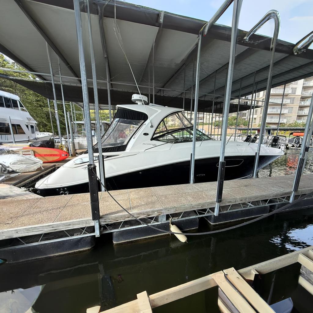 2009 Sea Ray 350 Sundancer docked in a marina under a covered slip.