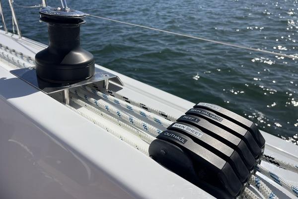Close-up of Hanse 360 sailboat rigging and winch, 2025 model, on open water.