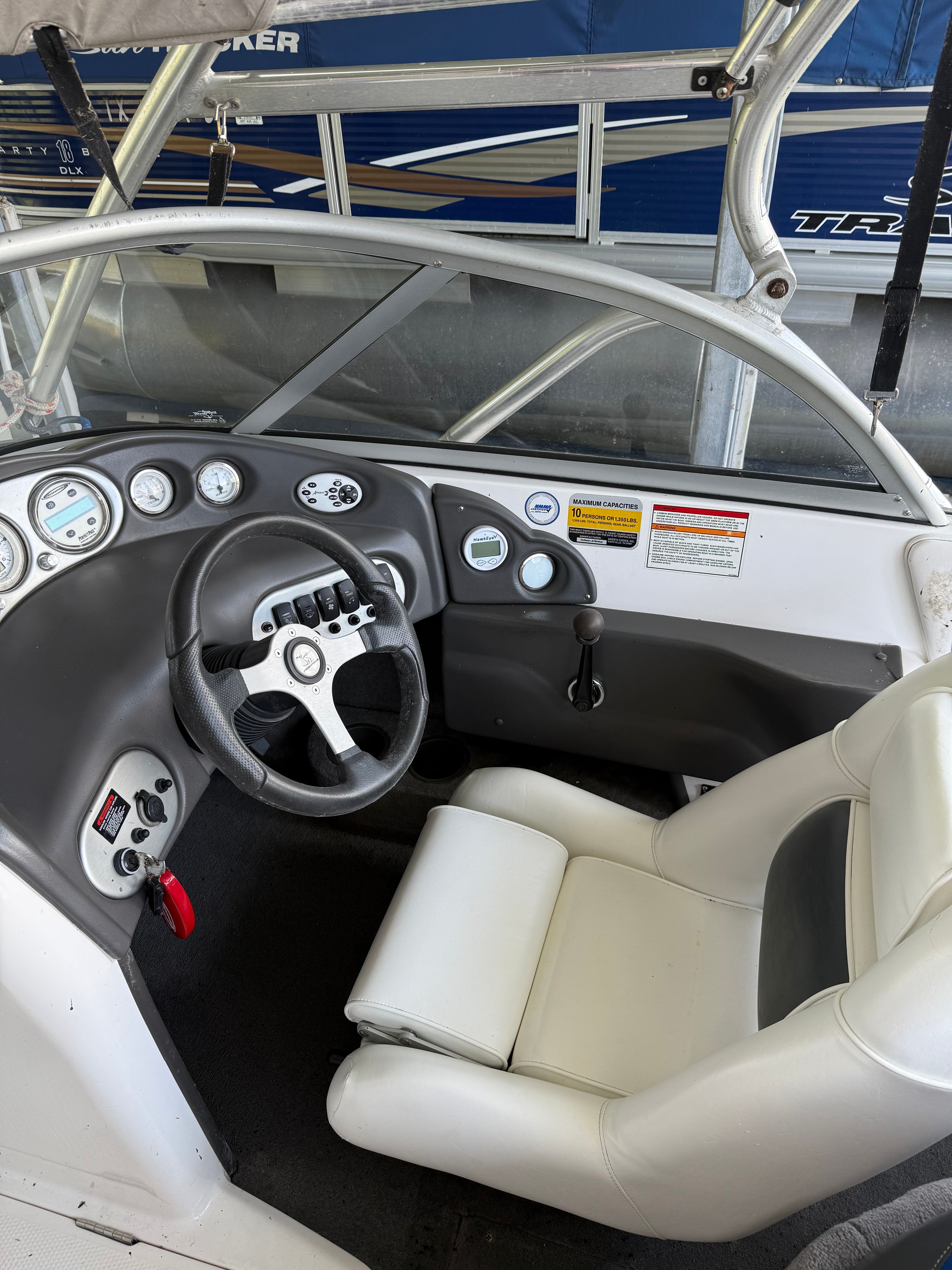 The image shows the cockpit of a 2005 Moomba Mobius LS with a white seat and black dashboard.
