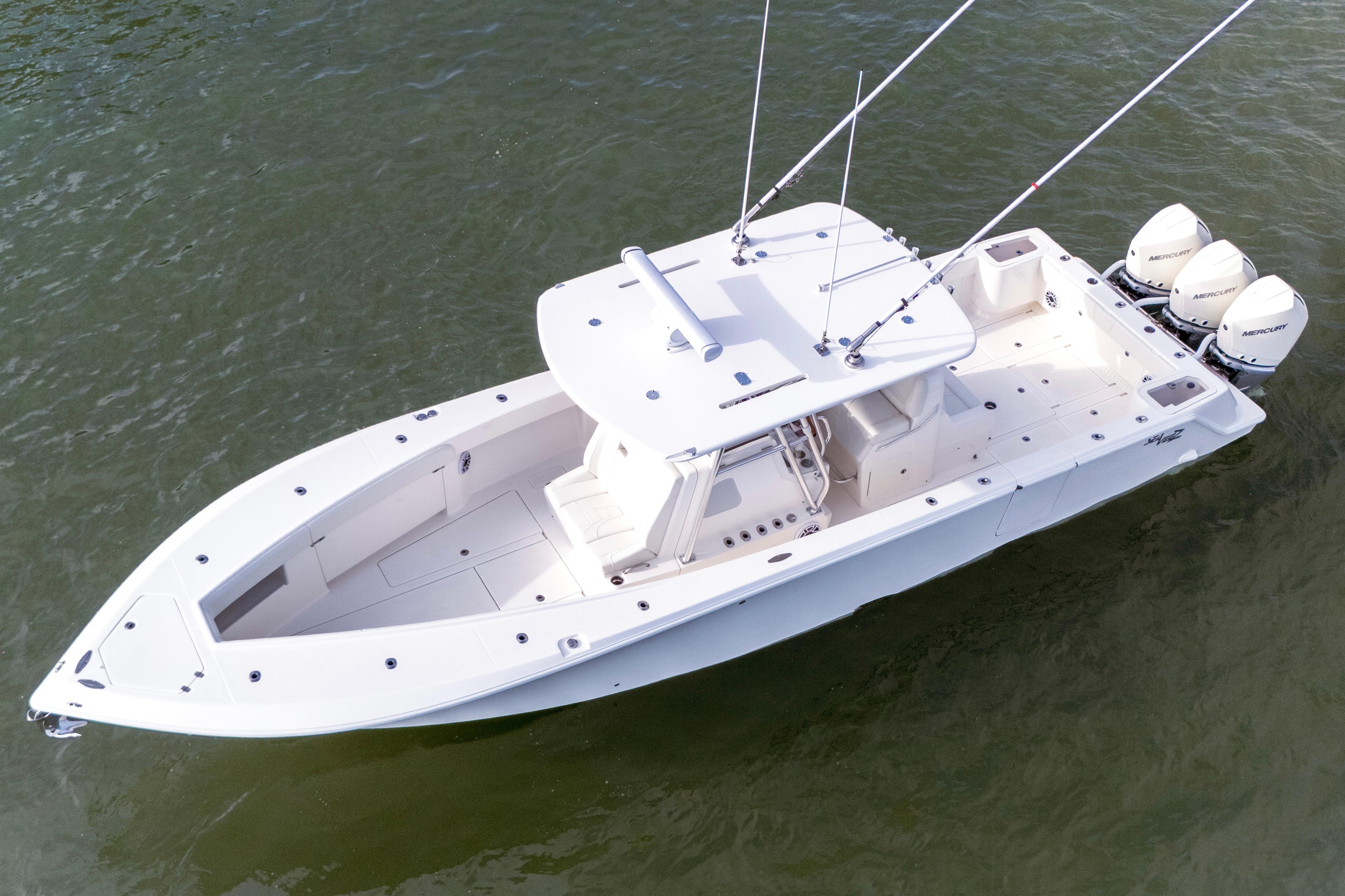 2022 SeaVee 370Z boat with triple outboard engines on calm water.
