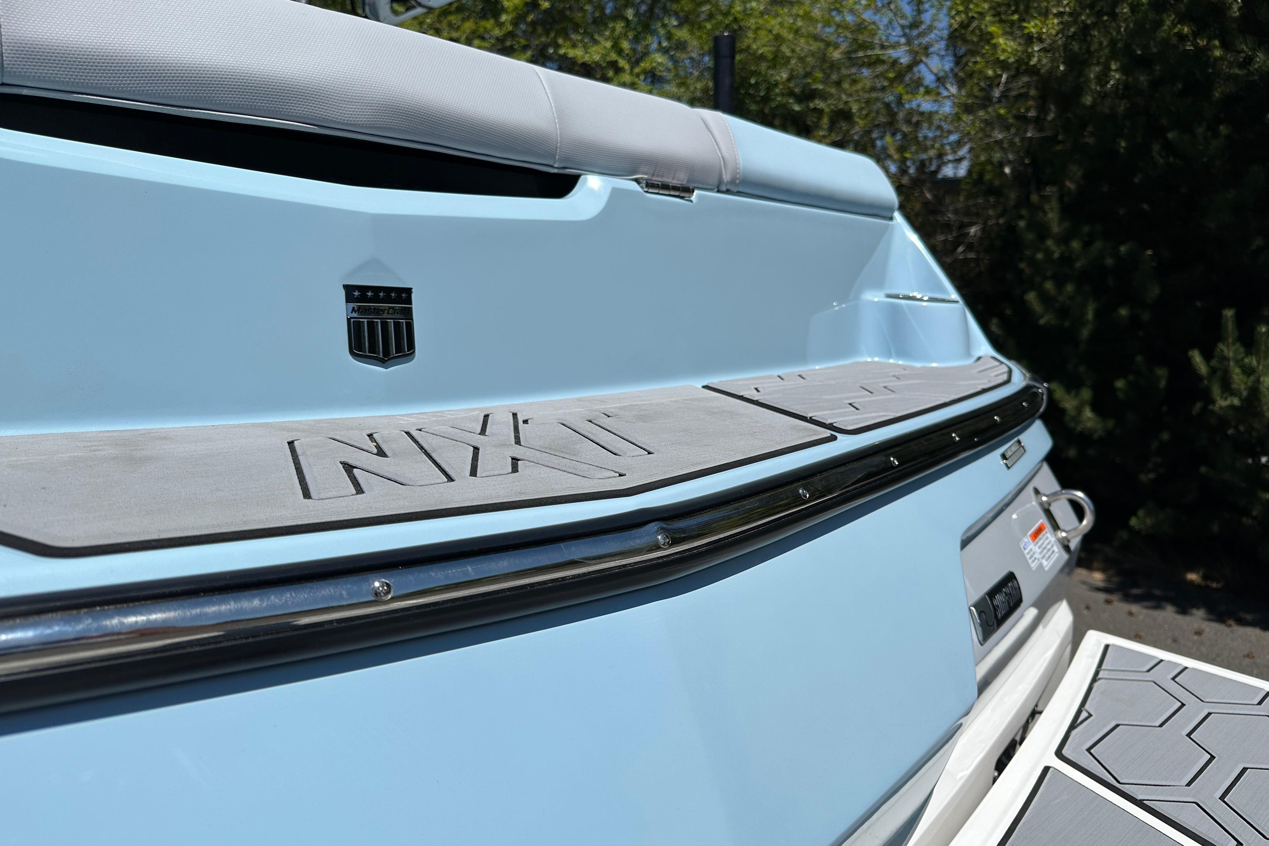 2023 MasterCraft NXT23 boat rear view with sleek design and branding details.