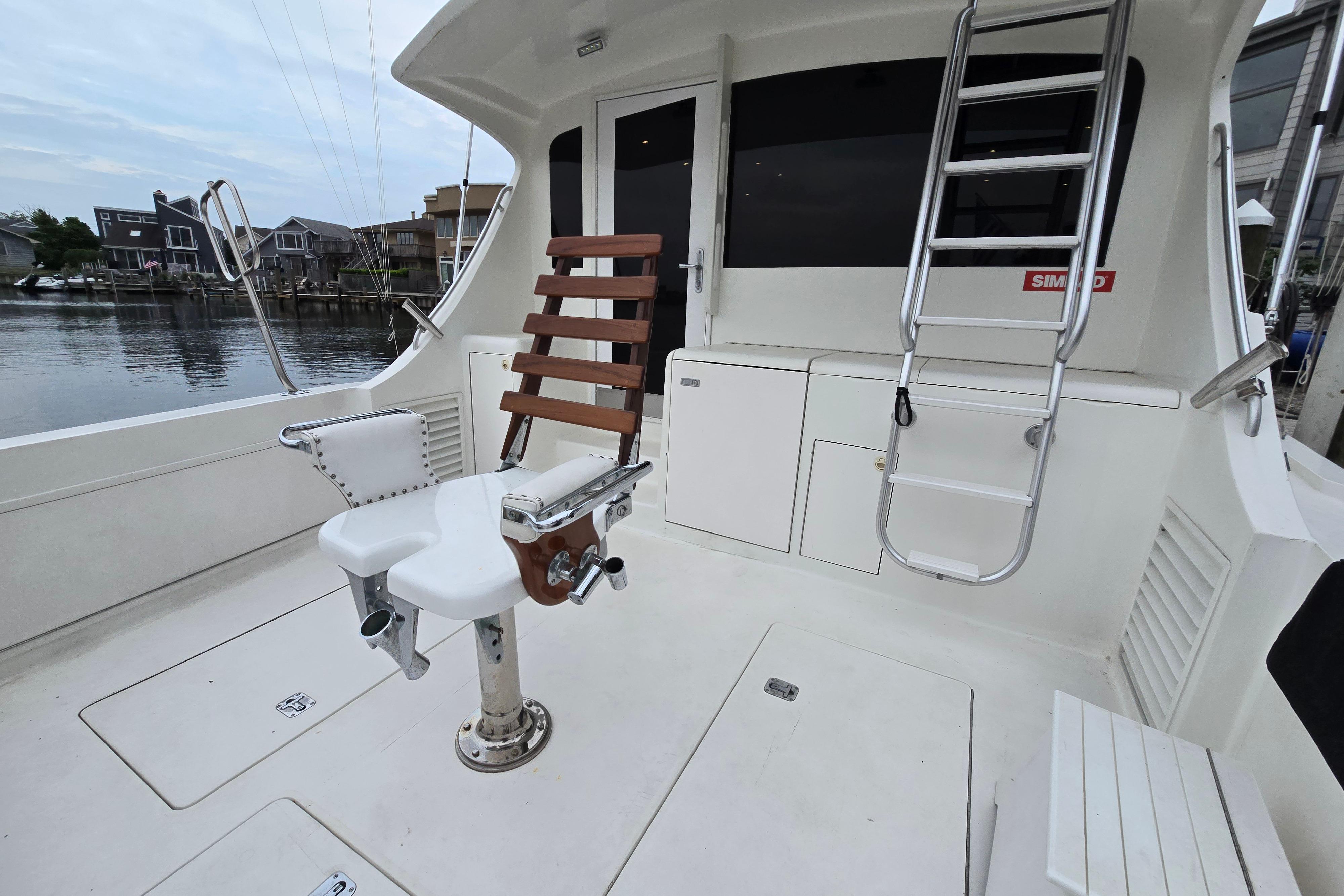 2001 Cavileer 53 Convertible yacht deck with fishing chair and ladder.