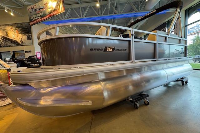 2026 Sun Tracker Bass Buggy 16 XL Select pontoon boat displayed indoors.