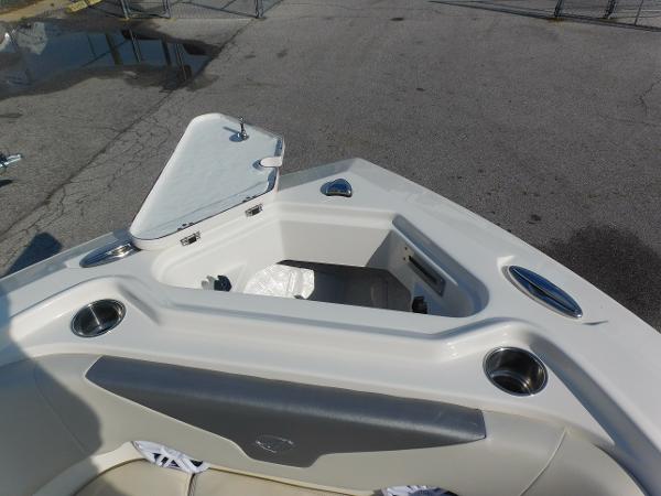 2025 Sailfish 232 CC boat bow storage compartment with open hatch and cup holders.