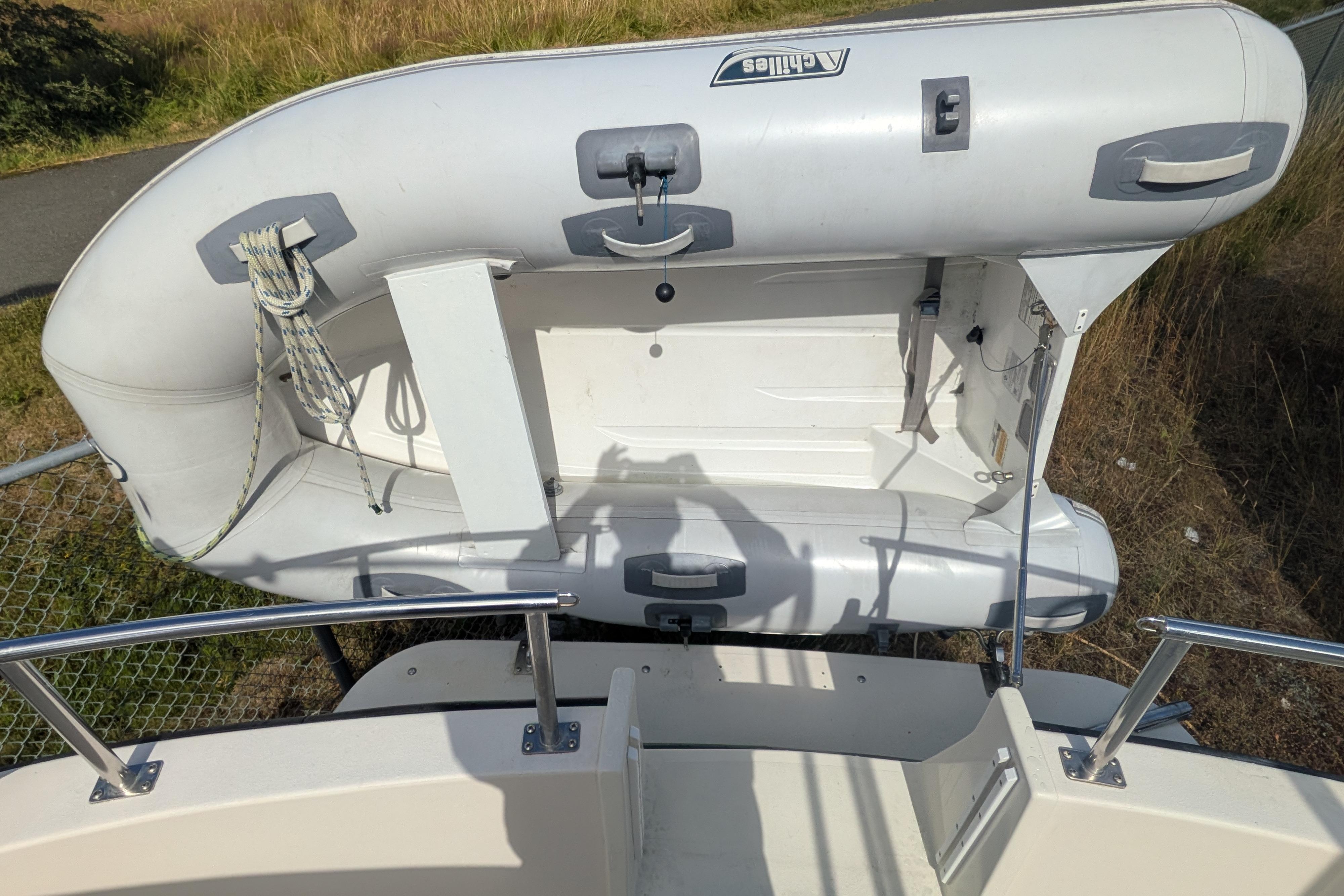 Inflatable dinghy mounted on a 1998 Nordic Tug 32 boat, viewed from above.